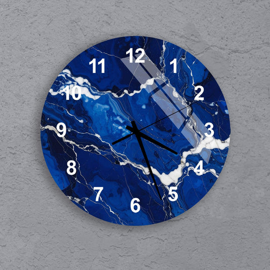 A blue and white clock with a marble-like pattern on its face, mounted on a gray wall.