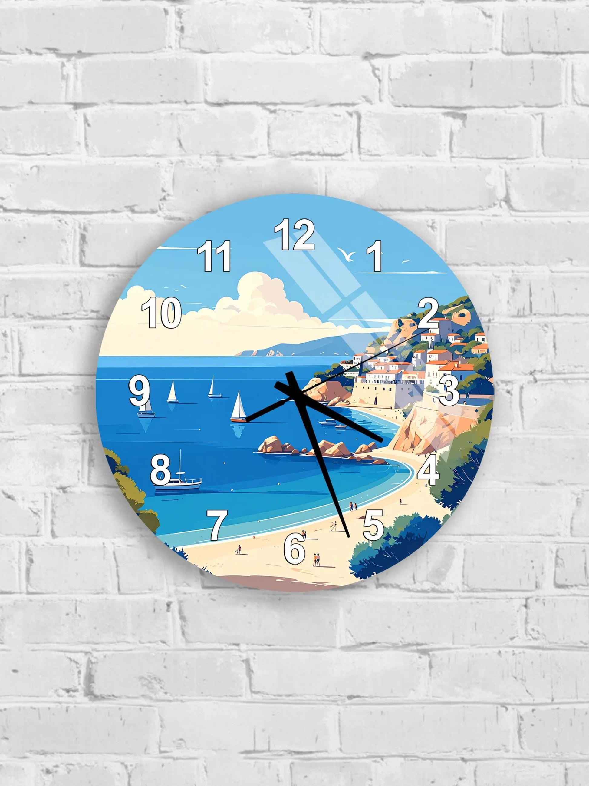 A wall clock with a beach scene and sailboats on the water.