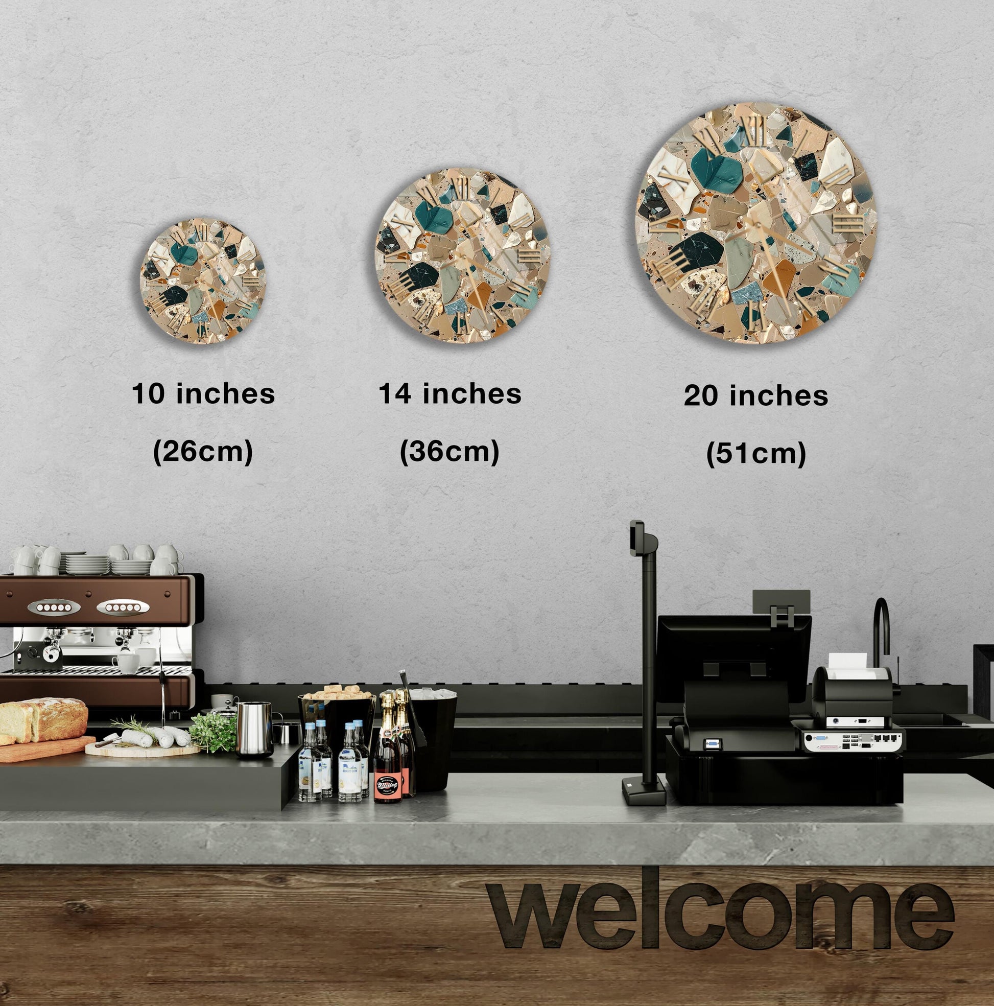 a counter in a restaurant with three different sizes of circular wall art displayed above it. The wall art is a mosaic design with various shades of brown, green, and beige colors. The counter has a cash register and other items on it, indicating that it is a commercial setting.