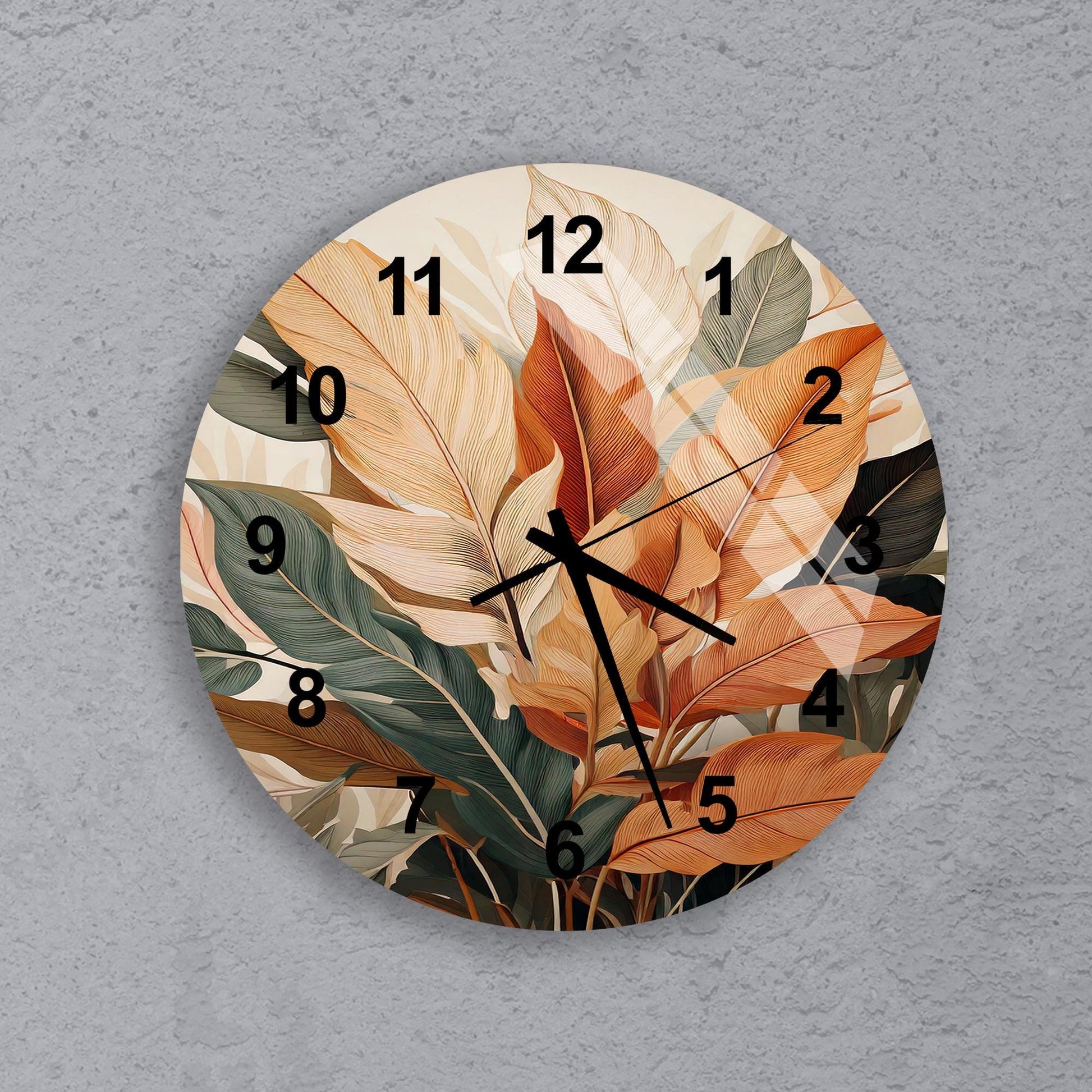 a clock with a painting of leaves on it
