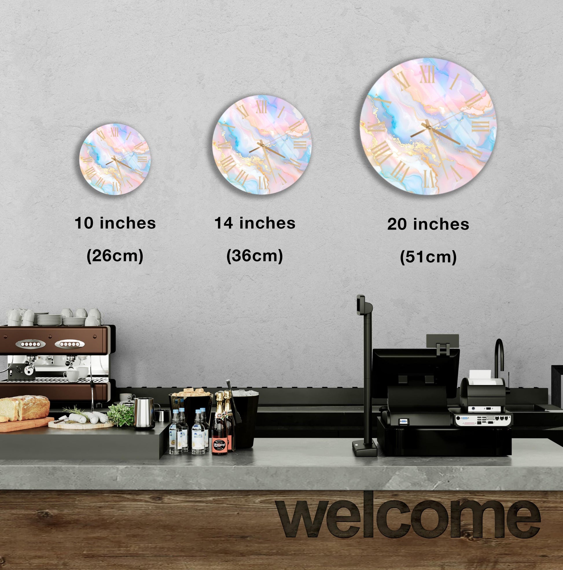 a wall with three round wall clocks of different sizes, each displaying a different time. Below the clocks, there is a counter with various items such as bottles and a sandwich. The word "welcome" is written on the counter.