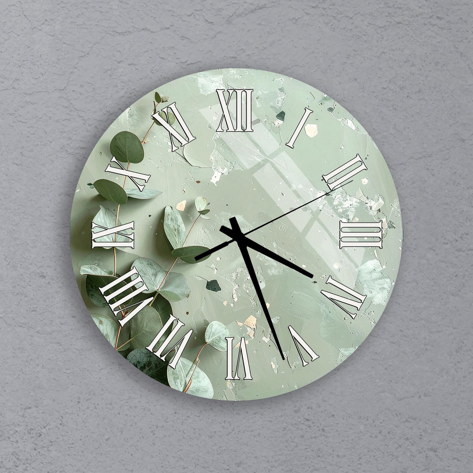 A round wall clock with a green and white color scheme, featuring Roman numerals and leaves as decorative elements.