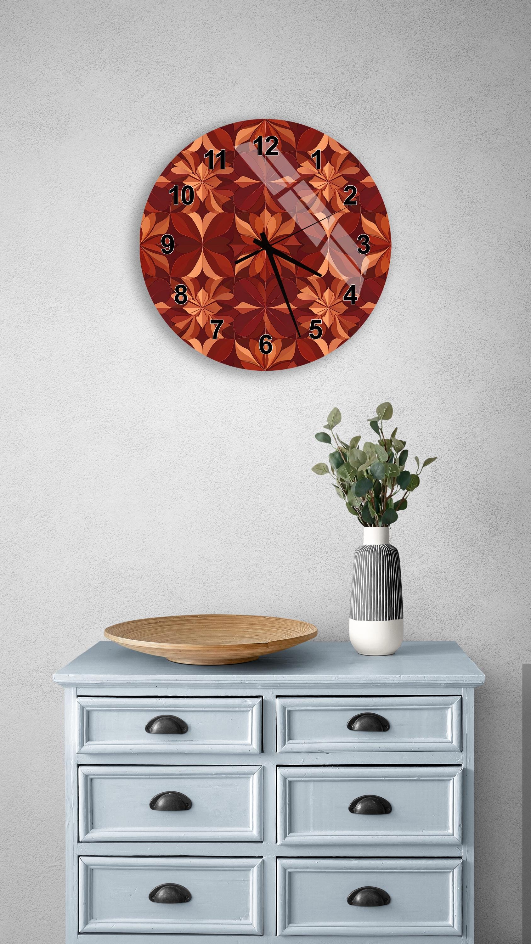 a wall clock with a floral design, a wooden tray, a vase with greenery, and a gray dresser with six drawers.