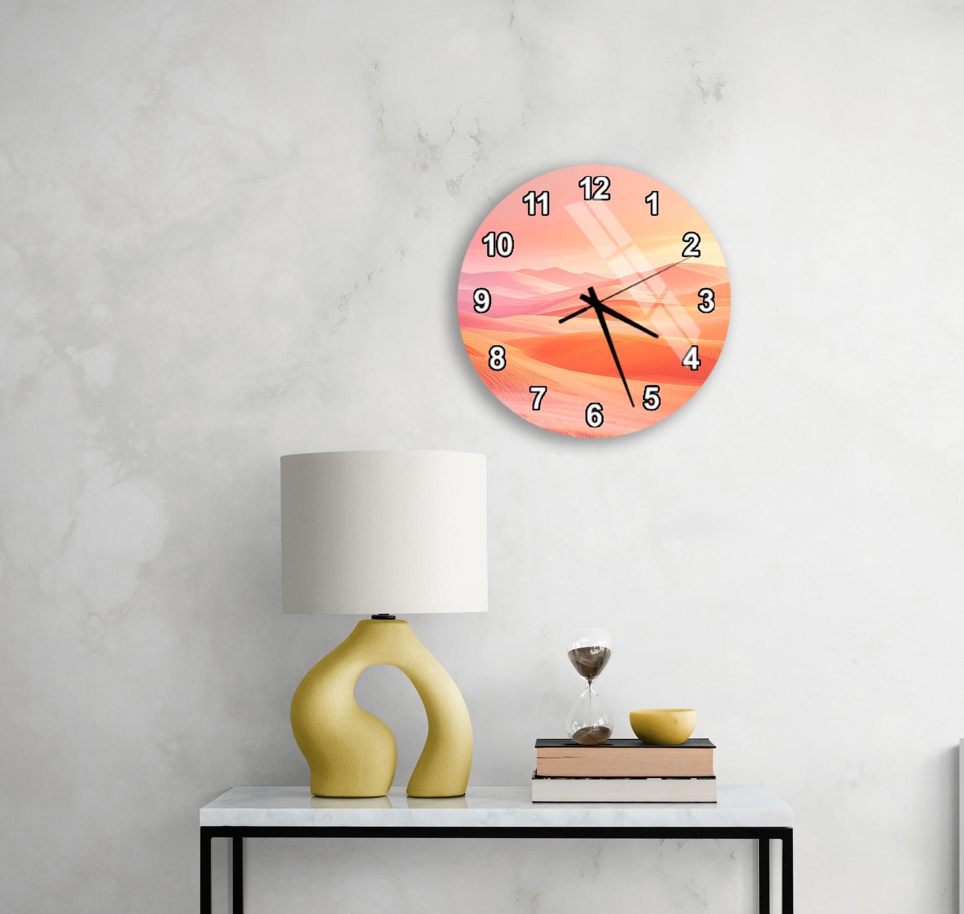 a modern living room with a round clock featuring a pink and orange design on the wall above a white table with a yellow lamp and a stack of books.