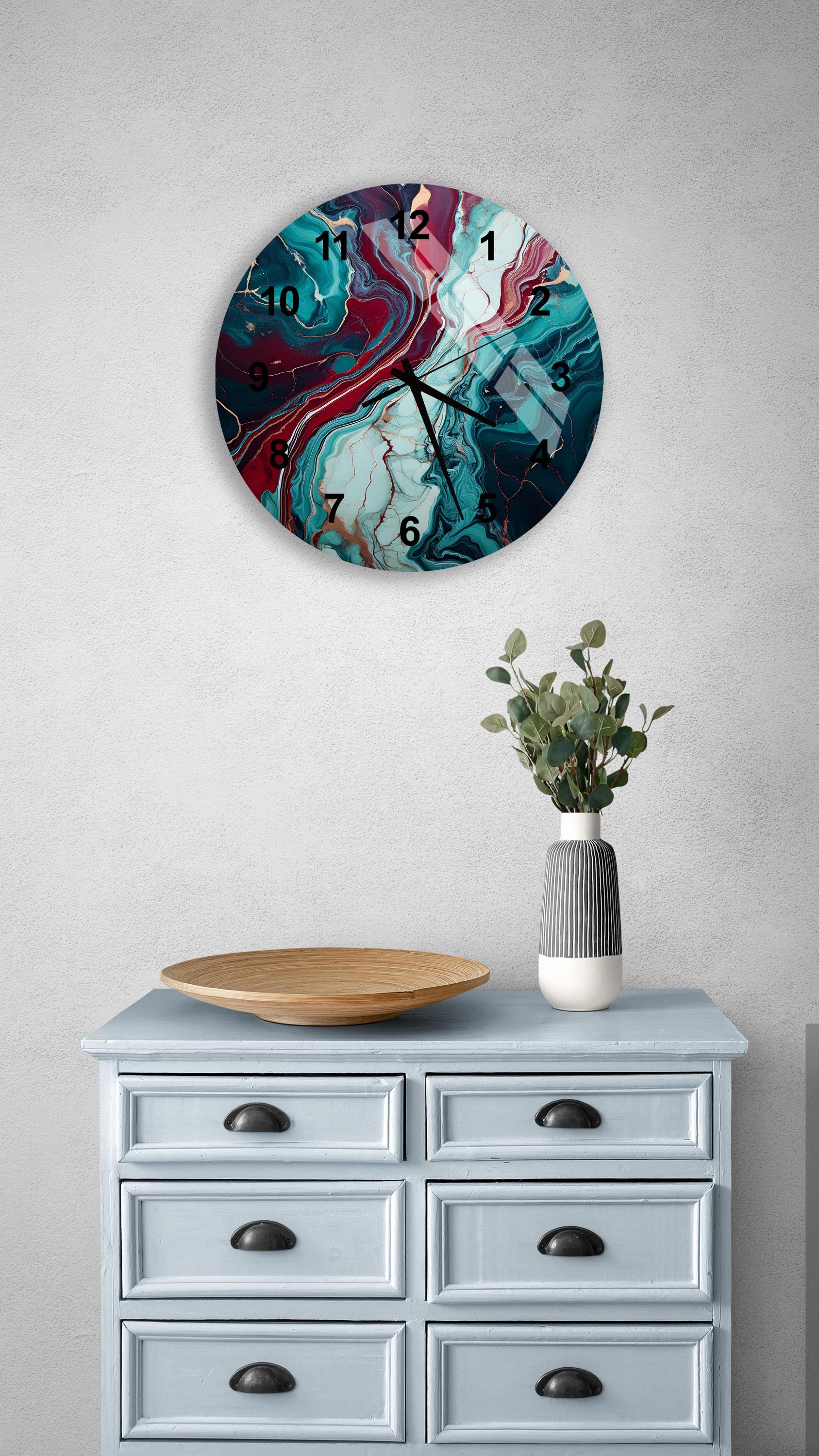 a blue dresser with a vase and a clock on it