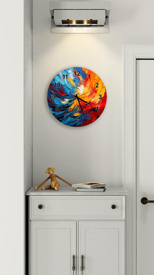 a colorful wall clock with a vibrant abstract design, mounted on a white wall above a white cabinet.