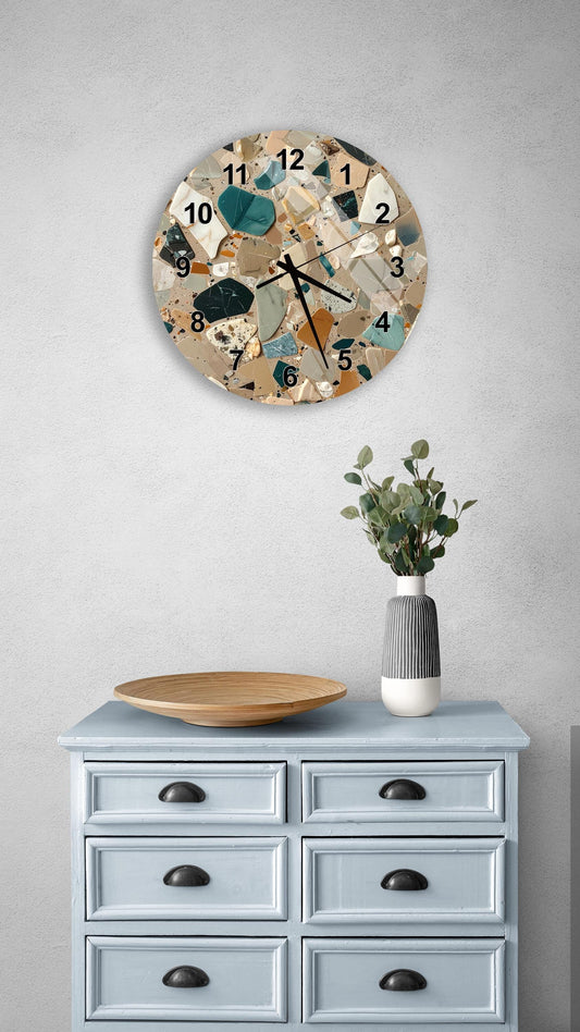 a wall clock with a unique, colorful design, a wooden tray on a light blue dresser, and a vase with greenery.
