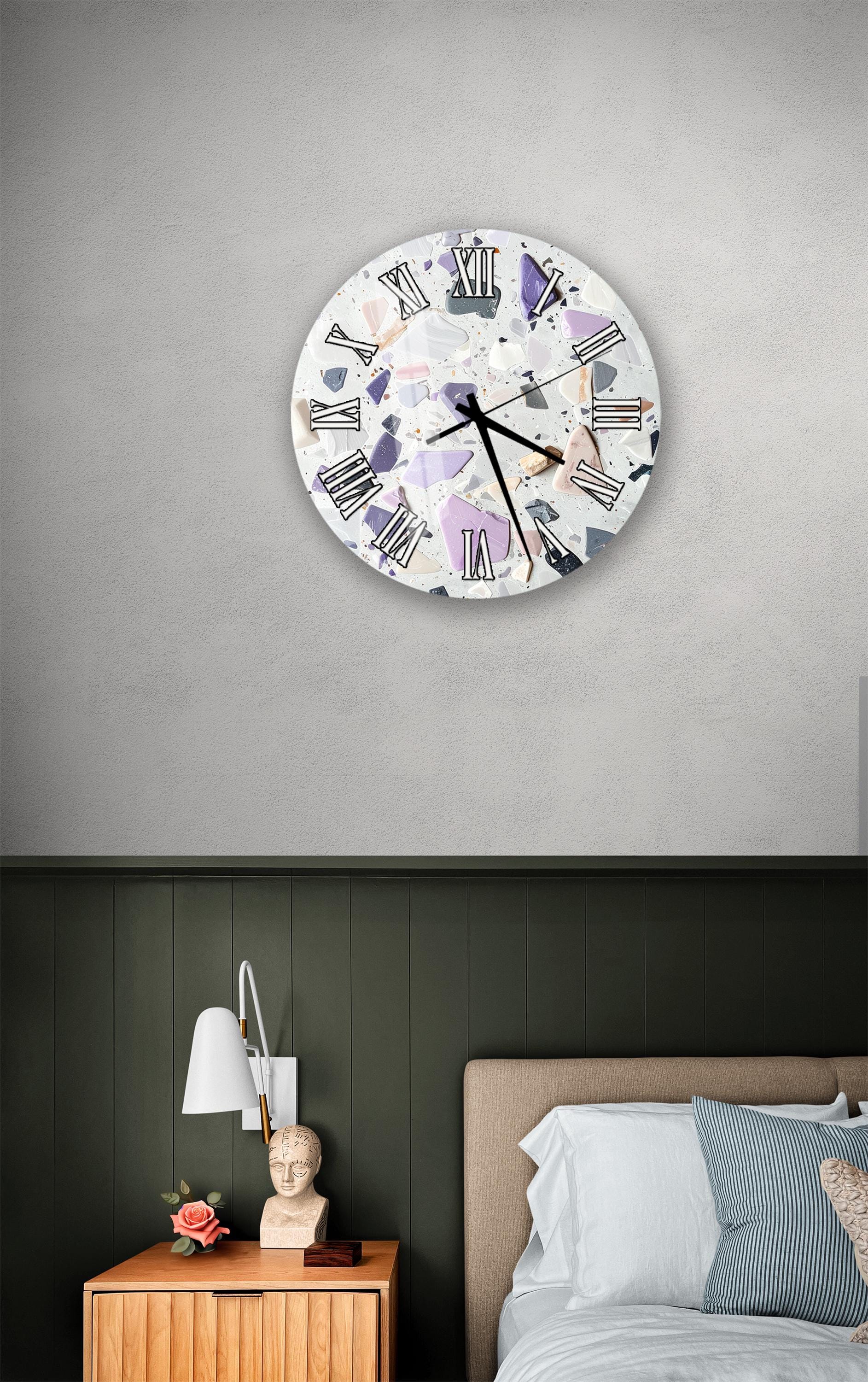 a bedroom setting with a wall clock, a nightstand, and a bed.