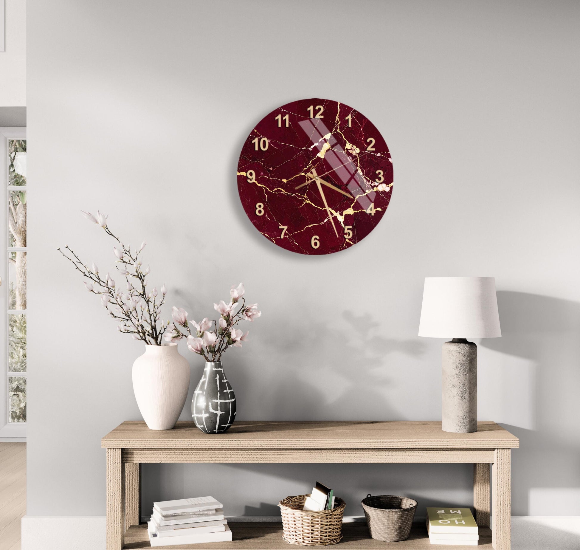 a modern living room with a wooden table, a lamp, a clock, and some decorative items such as a vase with flowers and a book.