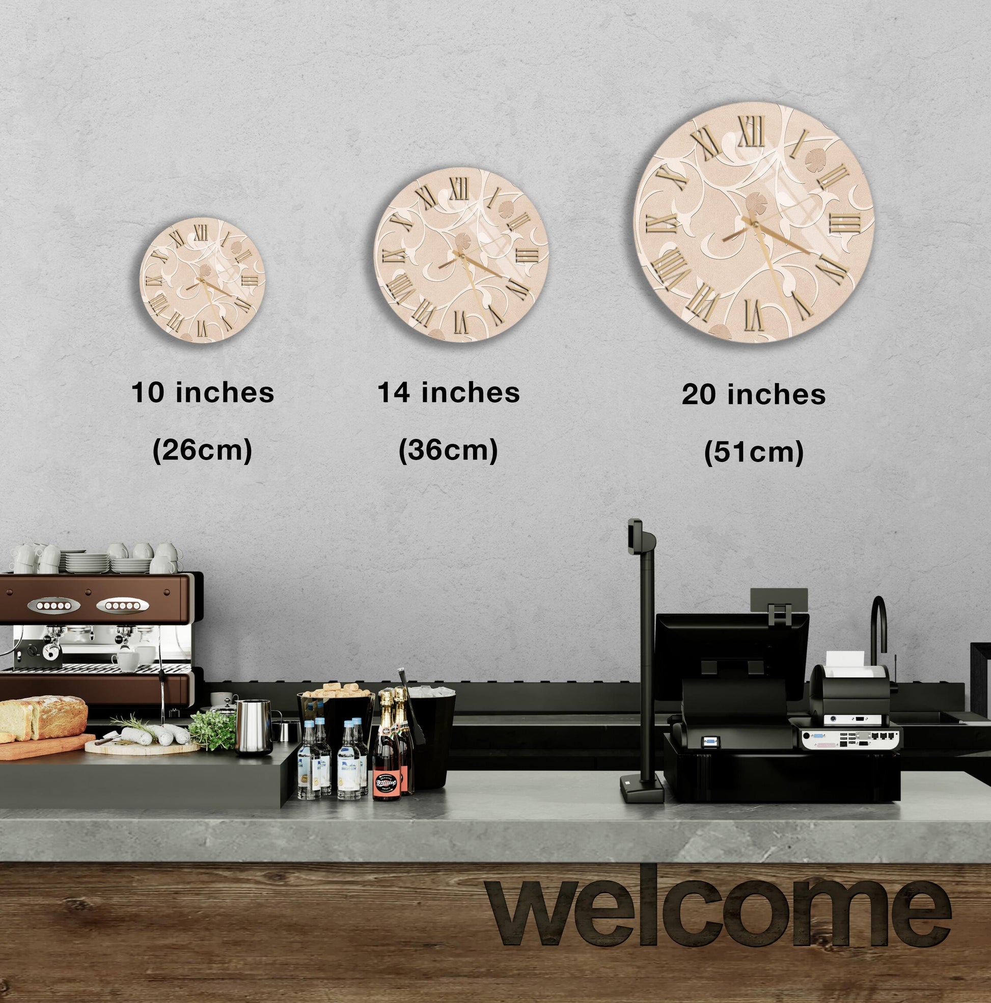 a wall with three different clock sizes, ranging from 10 inches to 20 inches in diameter, and a counter with various items such as bottles and a sandwich.