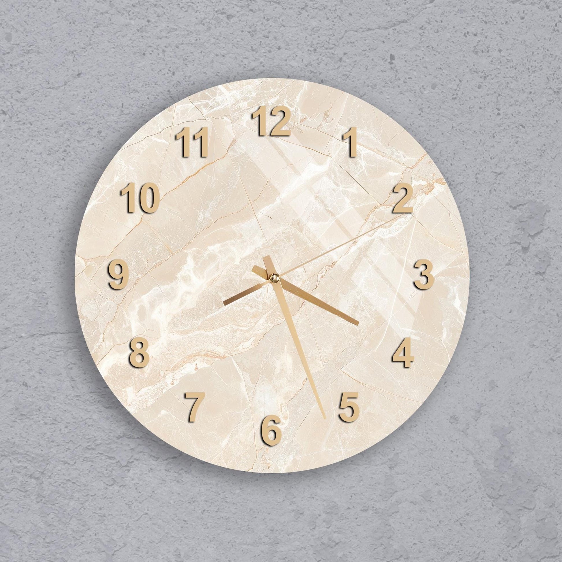 A round wall clock with a marble-like finish and gold hands and numbers.