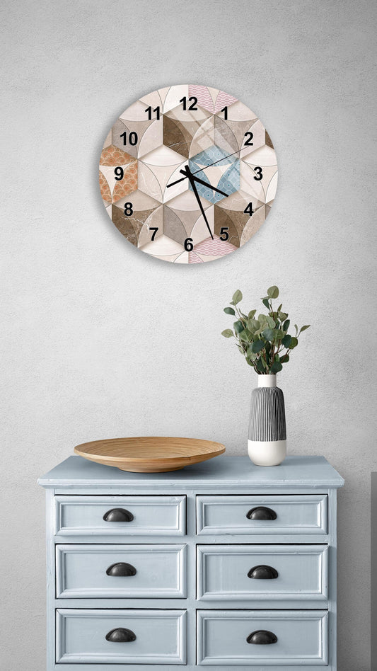 a wall clock with a geometric pattern, a wooden bowl, and a vase with greenery on a light blue dresser.