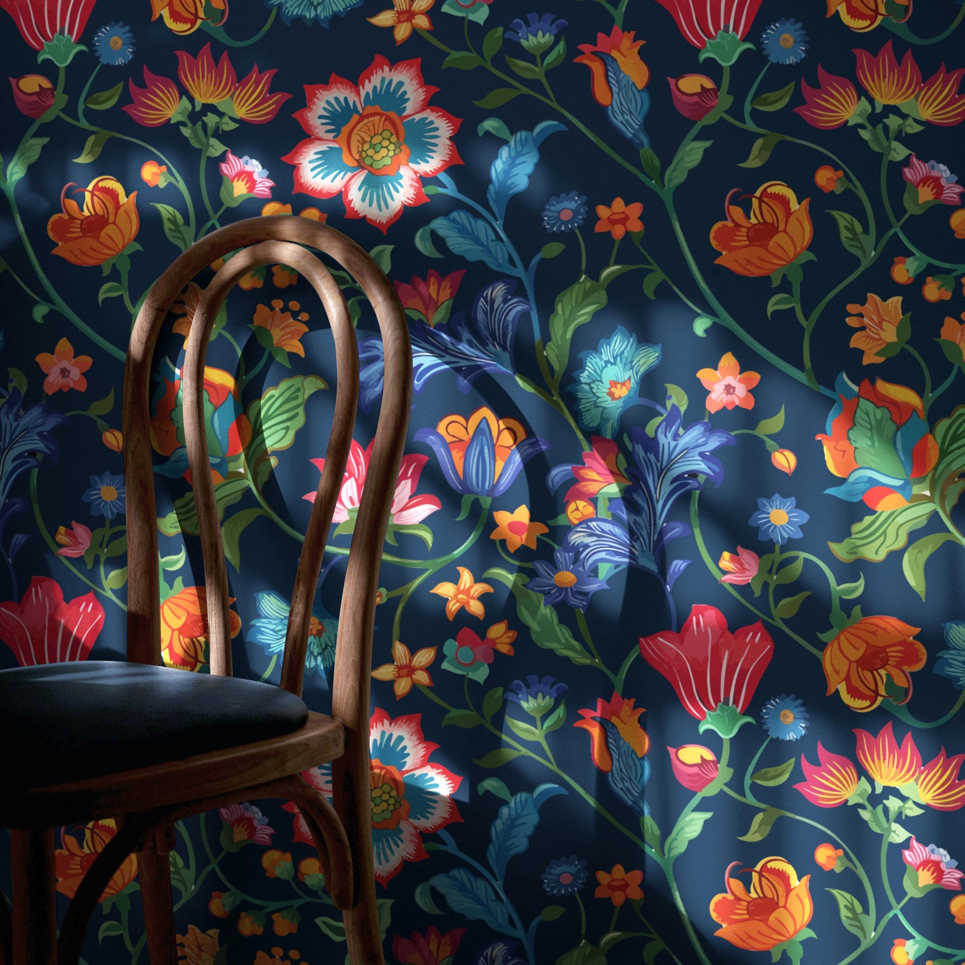 a wooden chair with a vibrant floral pattern on the backrest and seat, set against a dark blue wall adorned with a colorful floral wallpaper.
