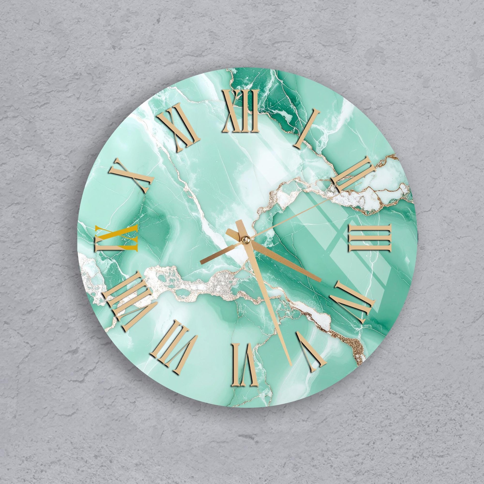 A round wall clock with a marble-like green and white color scheme, featuring gold Roman numerals and hands.