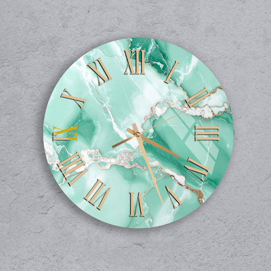A round wall clock with a marble-like green and white color scheme, featuring gold Roman numerals and hands.