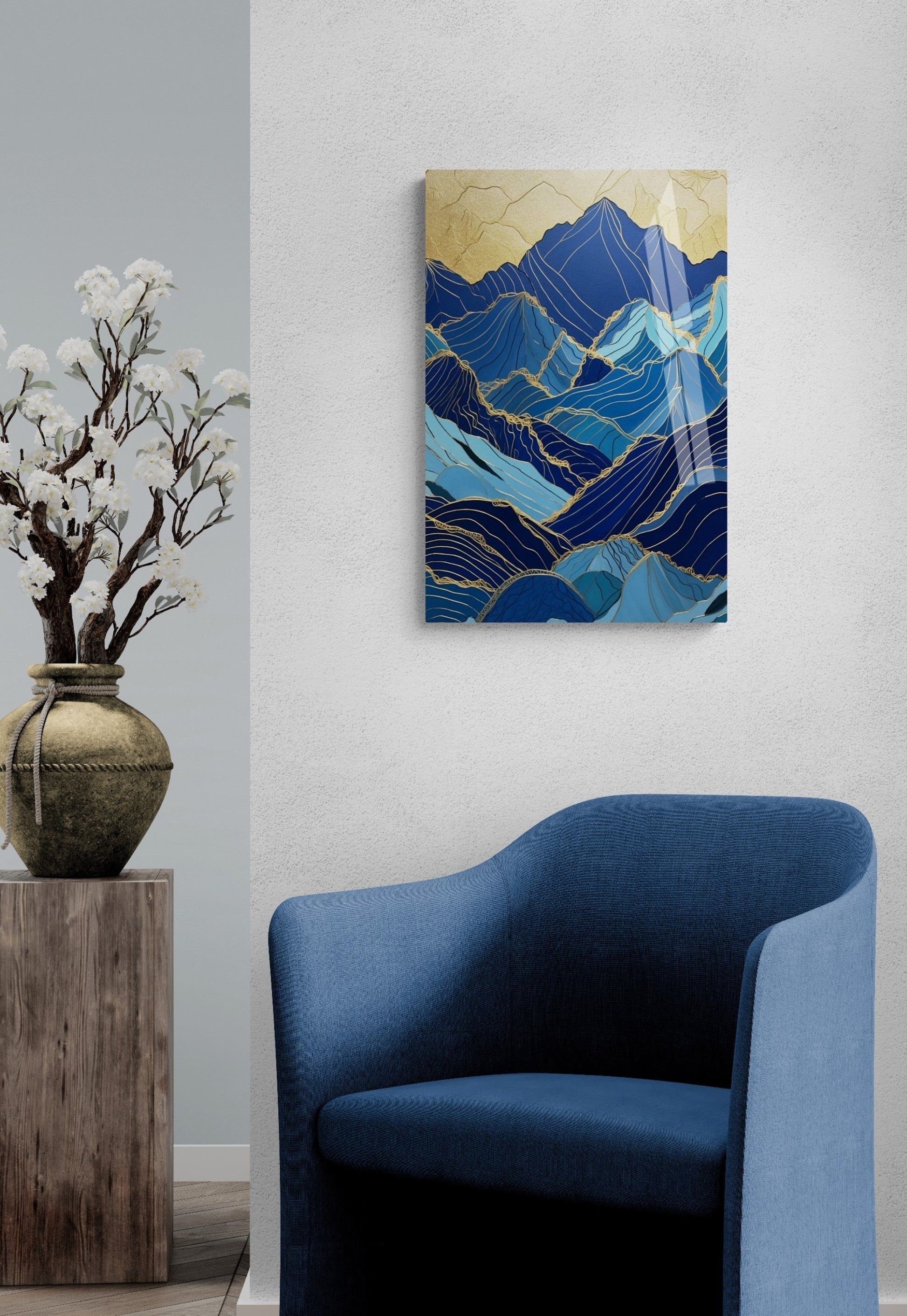a blue chair sitting next to a vase with flowers in it