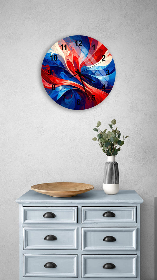 a wall clock with a vibrant, abstract design in red, white, and blue colors, hanging above a light blue dresser with six drawers. The dresser also has a small plant and a wooden bowl on top of it.
