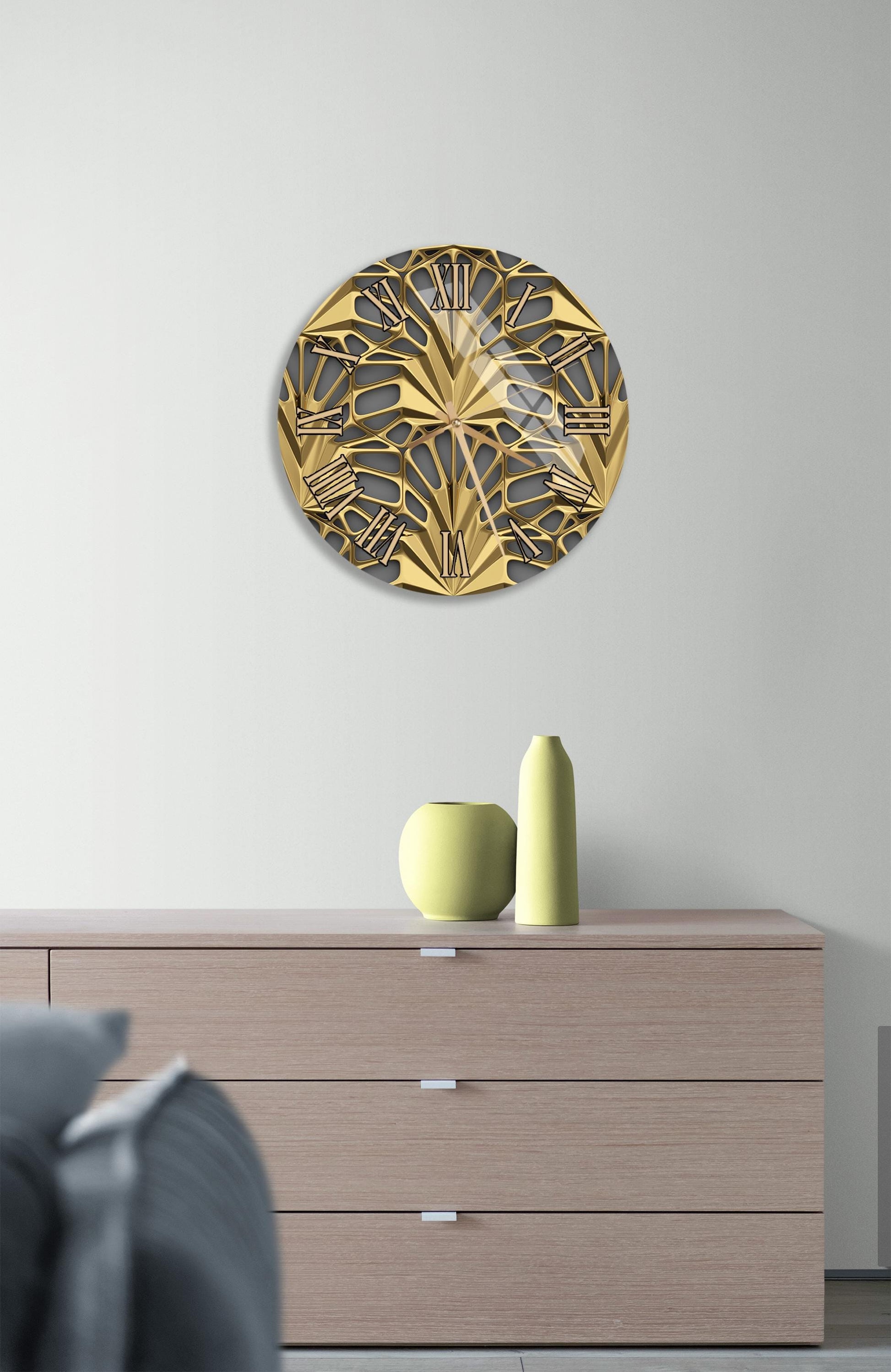 a modern interior design with a wooden dresser, a decorative gold-colored circular wall art piece, and a small green vase on the dresser.