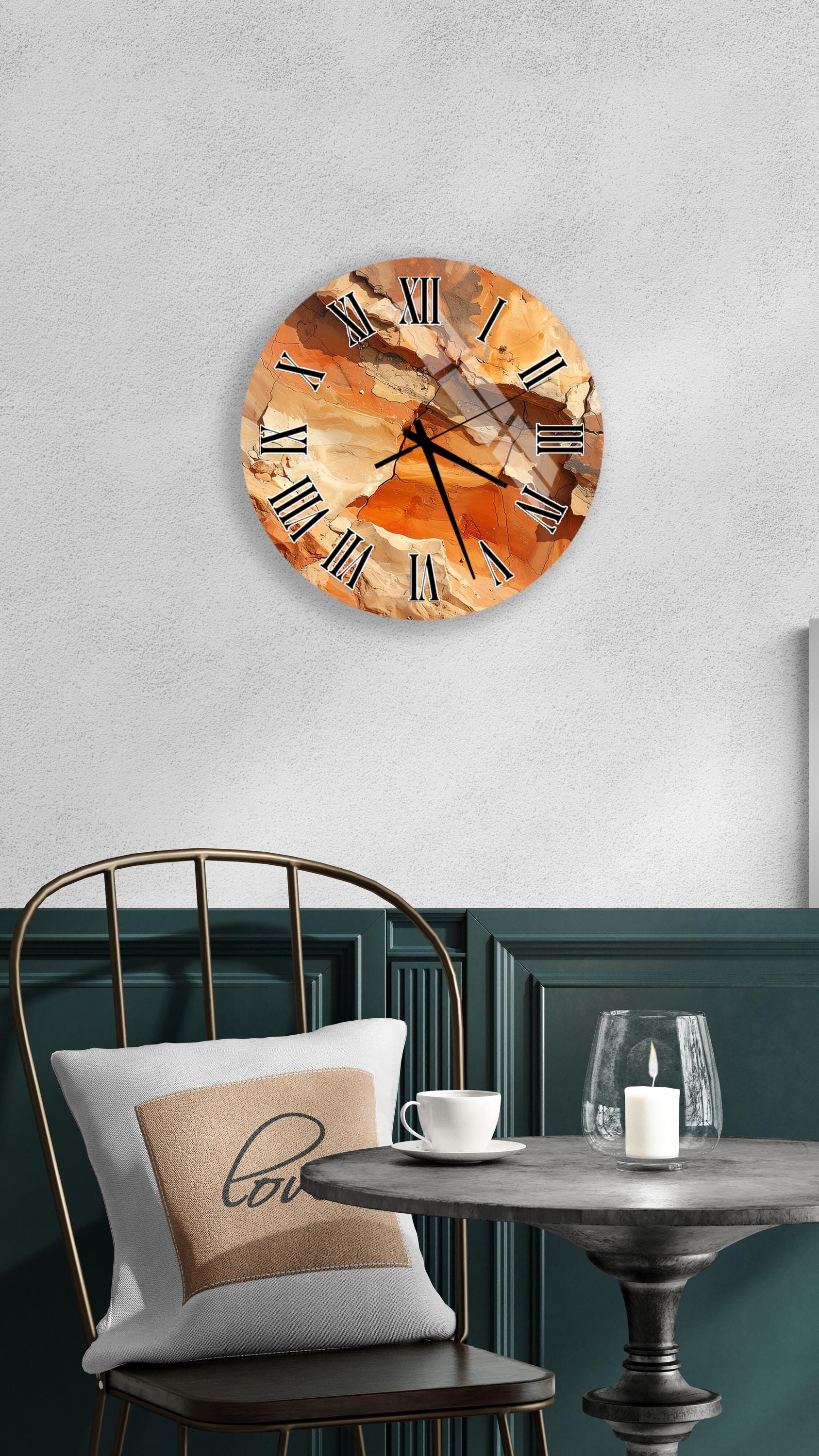 a round wall clock with an abstract design, mounted on a wall above a table with a white tablecloth.