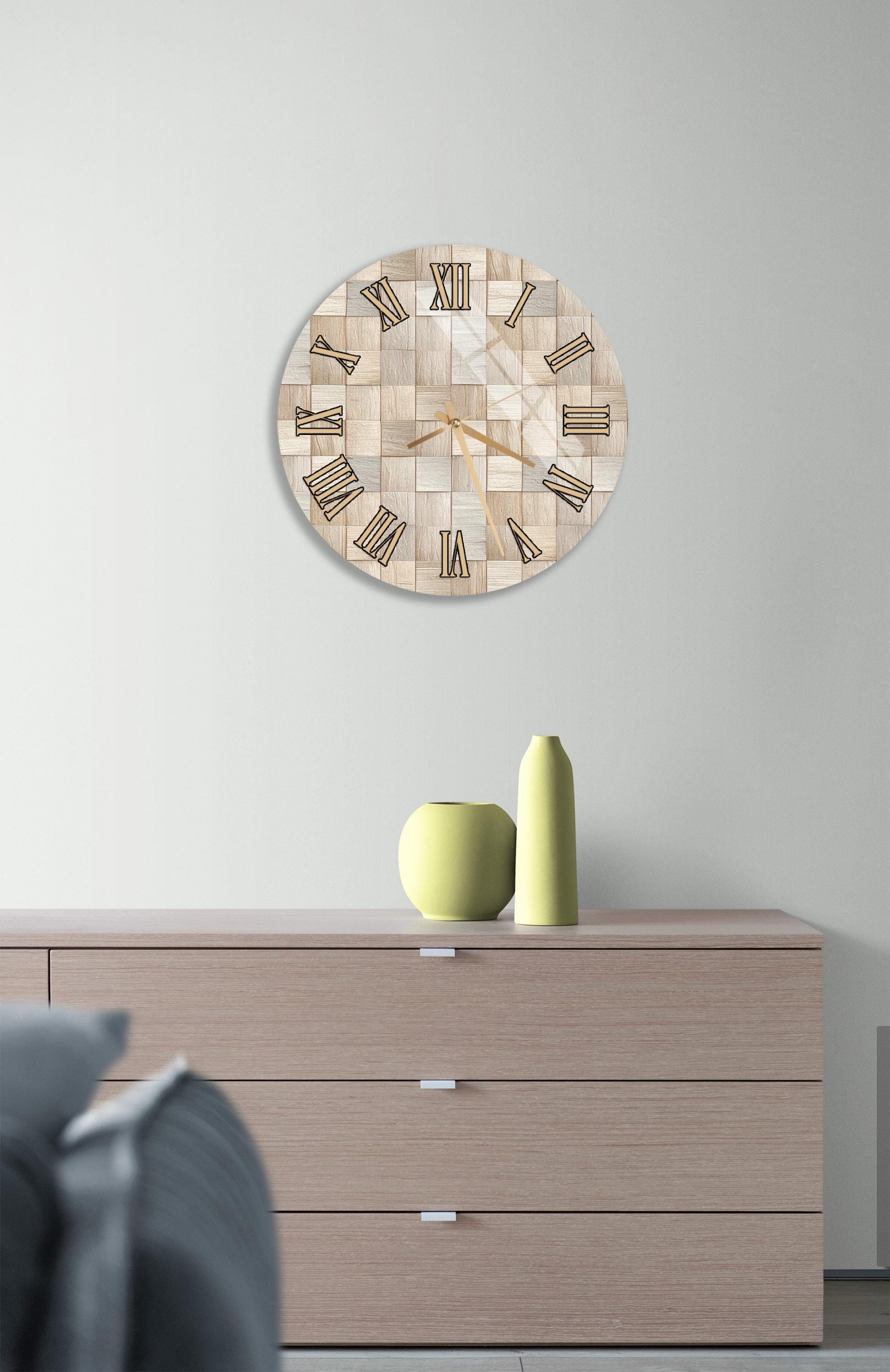 a modern living room with a wooden dresser, a round clock with a mosaic design, and a yellow vase on top of the dresser.