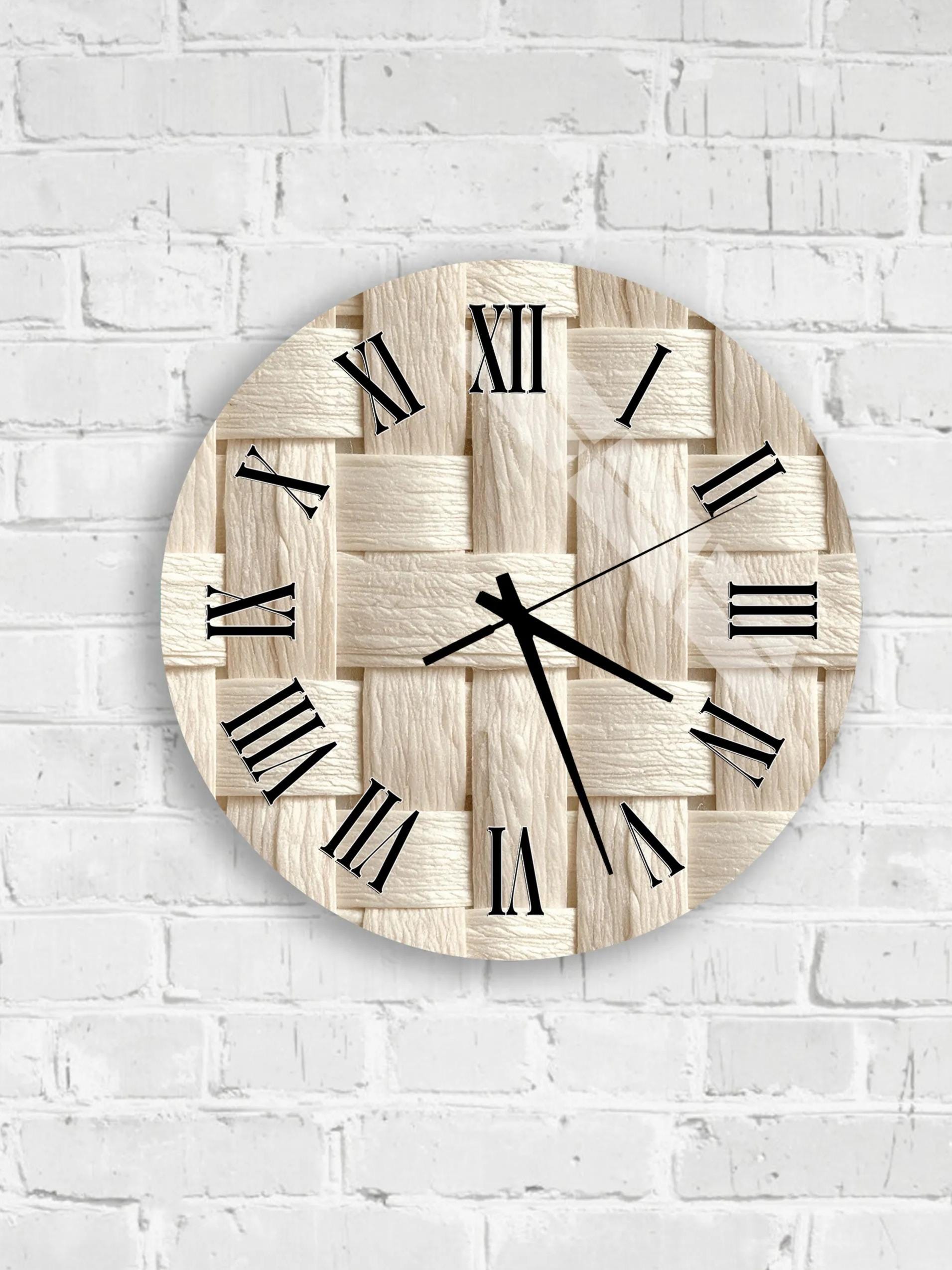 A round clock with Roman numerals on a white brick wall.