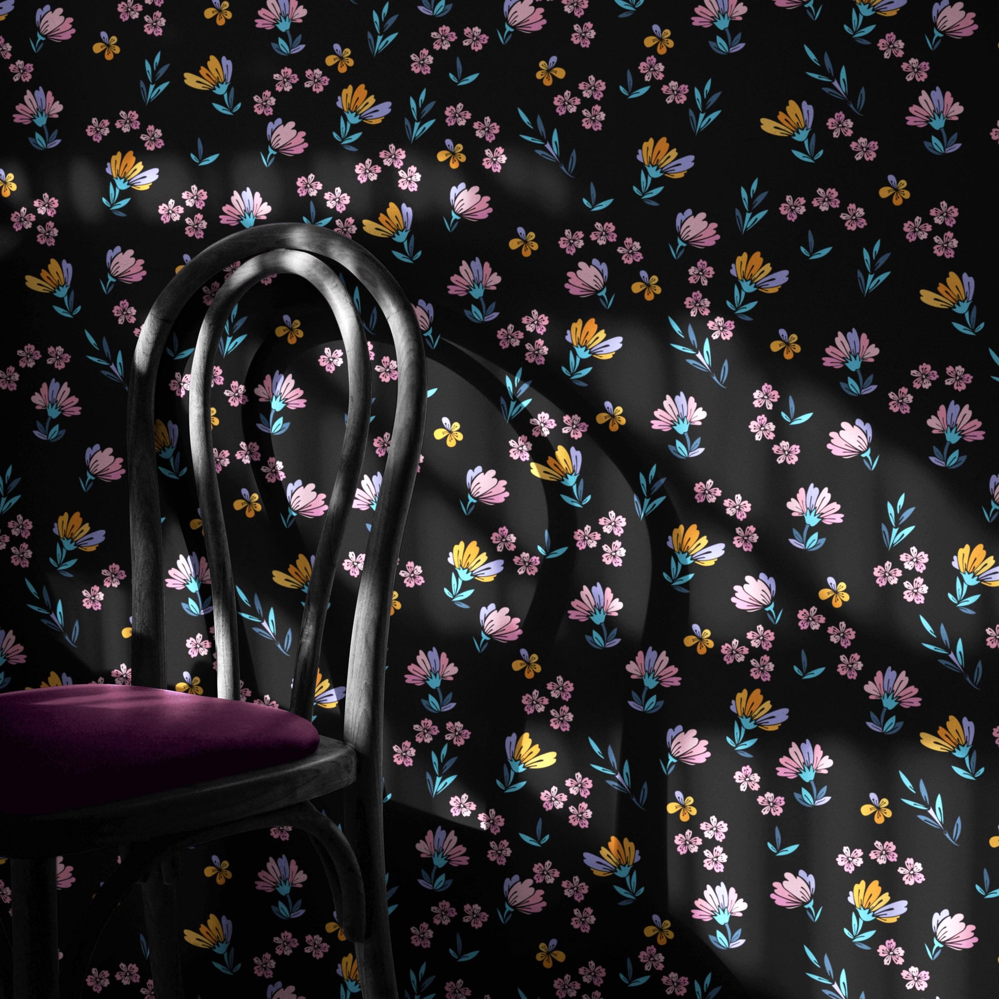 a black chair with a purple cushion, set against a wall adorned with a floral pattern in shades of pink, yellow, and blue.