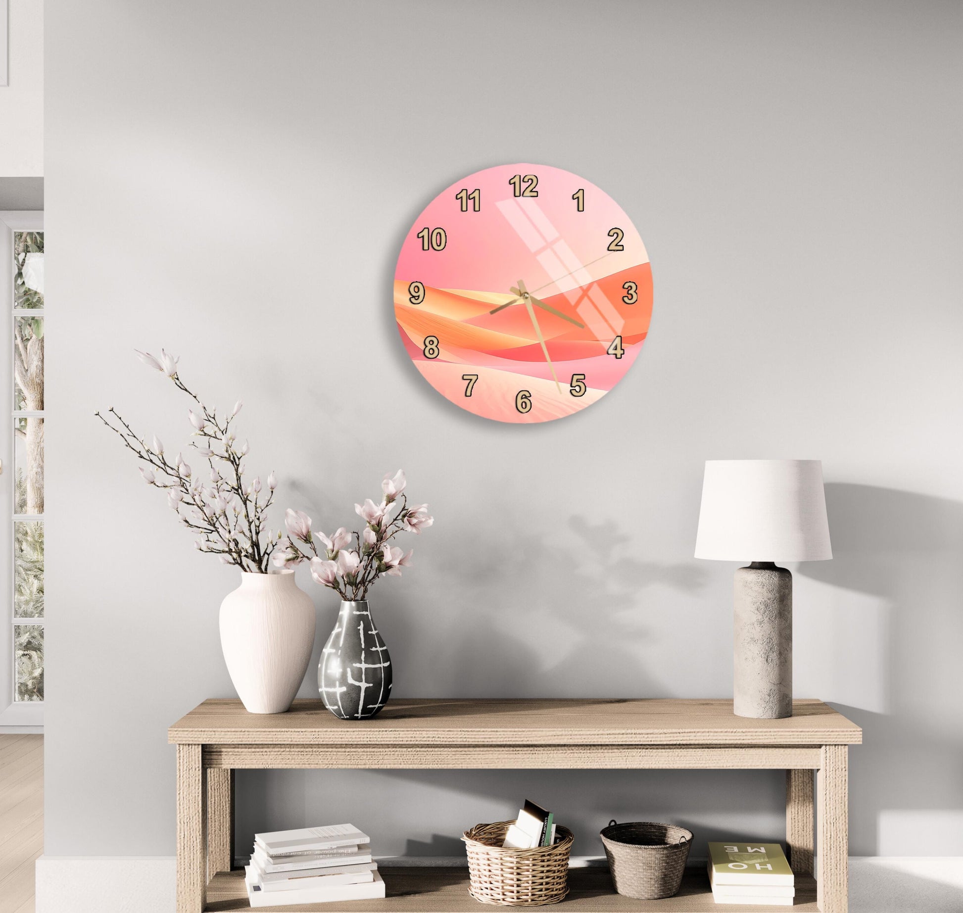 a modern and minimalist living room with a round clock on the wall, a wooden table with a lamp, a vase with flowers, and a stack of books.