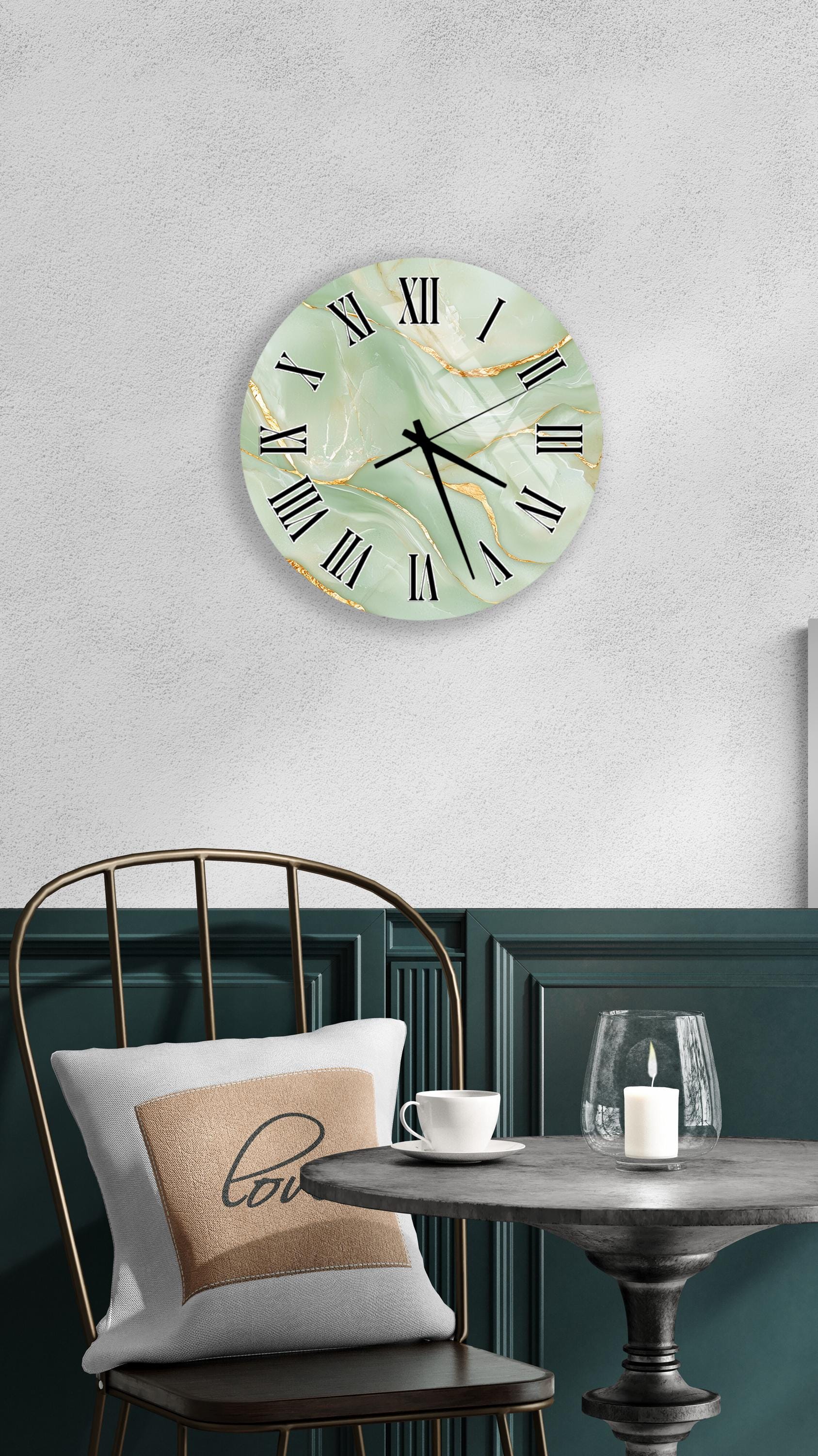 a modern and stylish interior design with a round wall clock, a black metal chair, a white table, and a beige pillow with the word "love" on it.