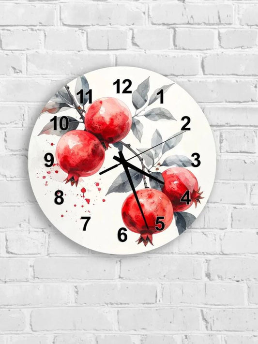 A wall clock with a white background and a design featuring red pomegranate fruits and leaves.