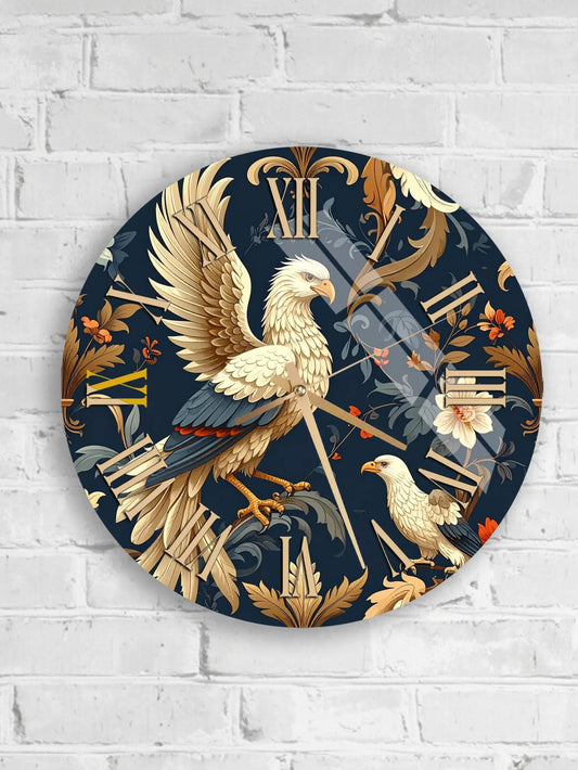 A round wall clock with a detailed design featuring a white bird, possibly a hawk or an eagle, against a dark blue background with floral and leaf patterns.