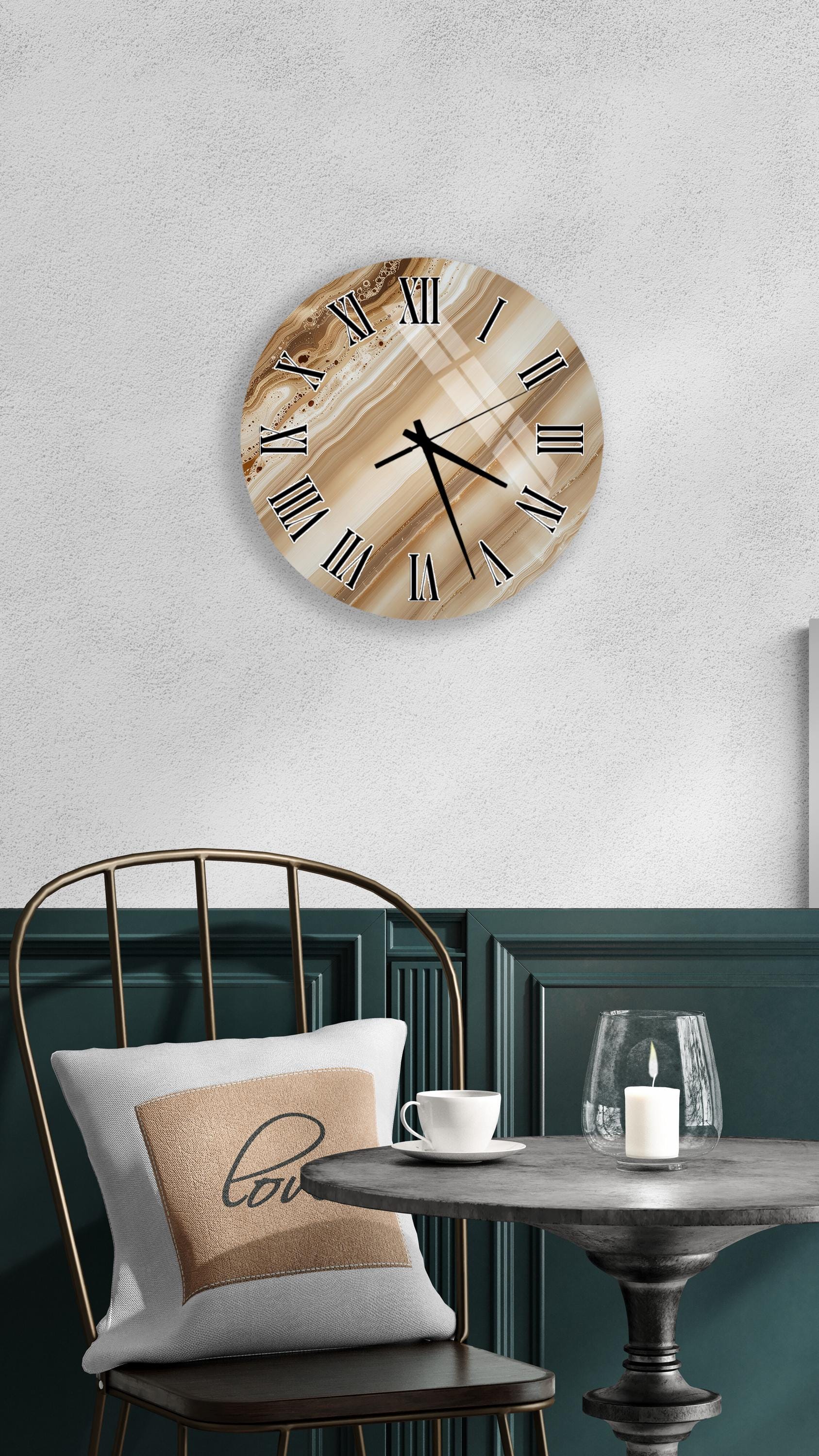 a modern interior design with a round wall clock, a white table with a candle, and a black chair with a pillow.