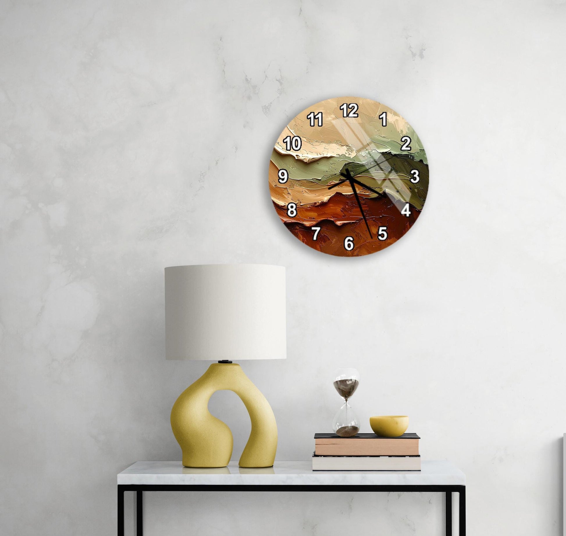 a modern wall clock with a unique design, a yellow lamp on a white table, and a stack of books and a glass of wine on the table.