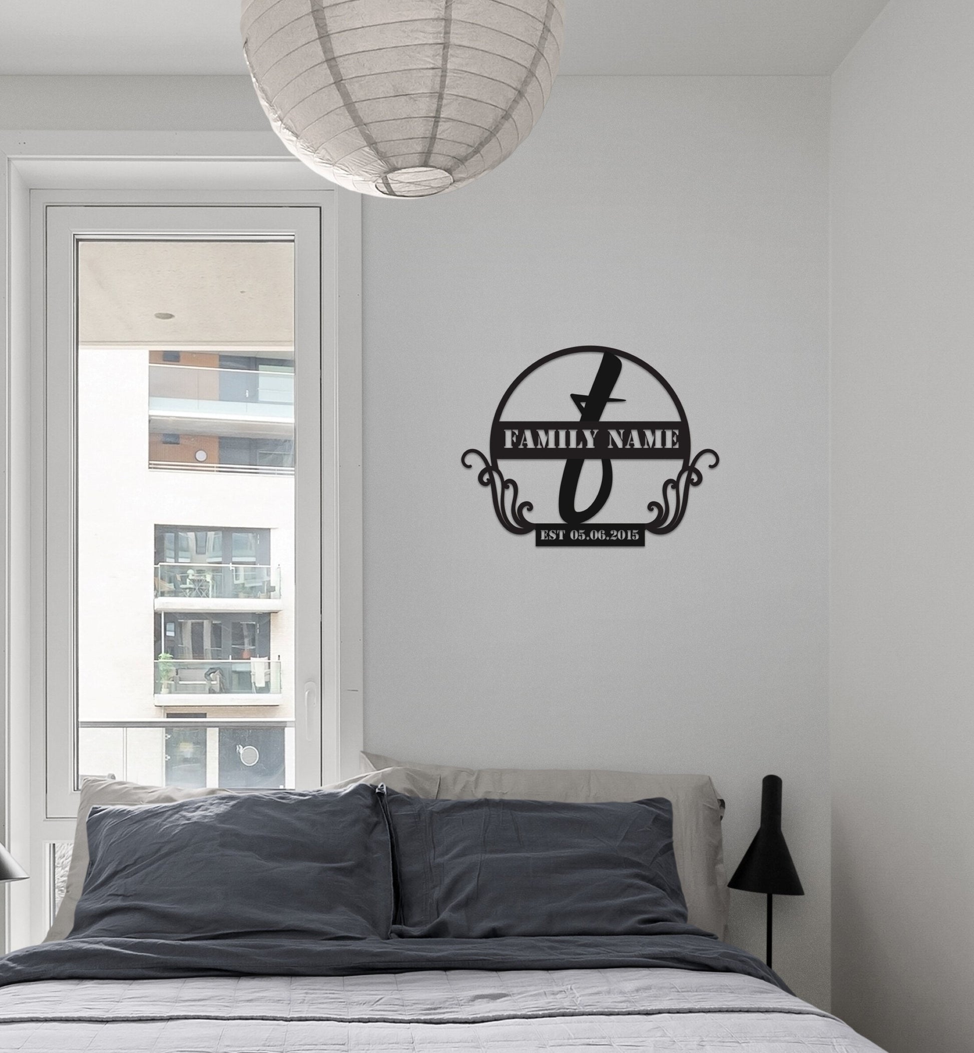a bed sitting under a window next to a lamp