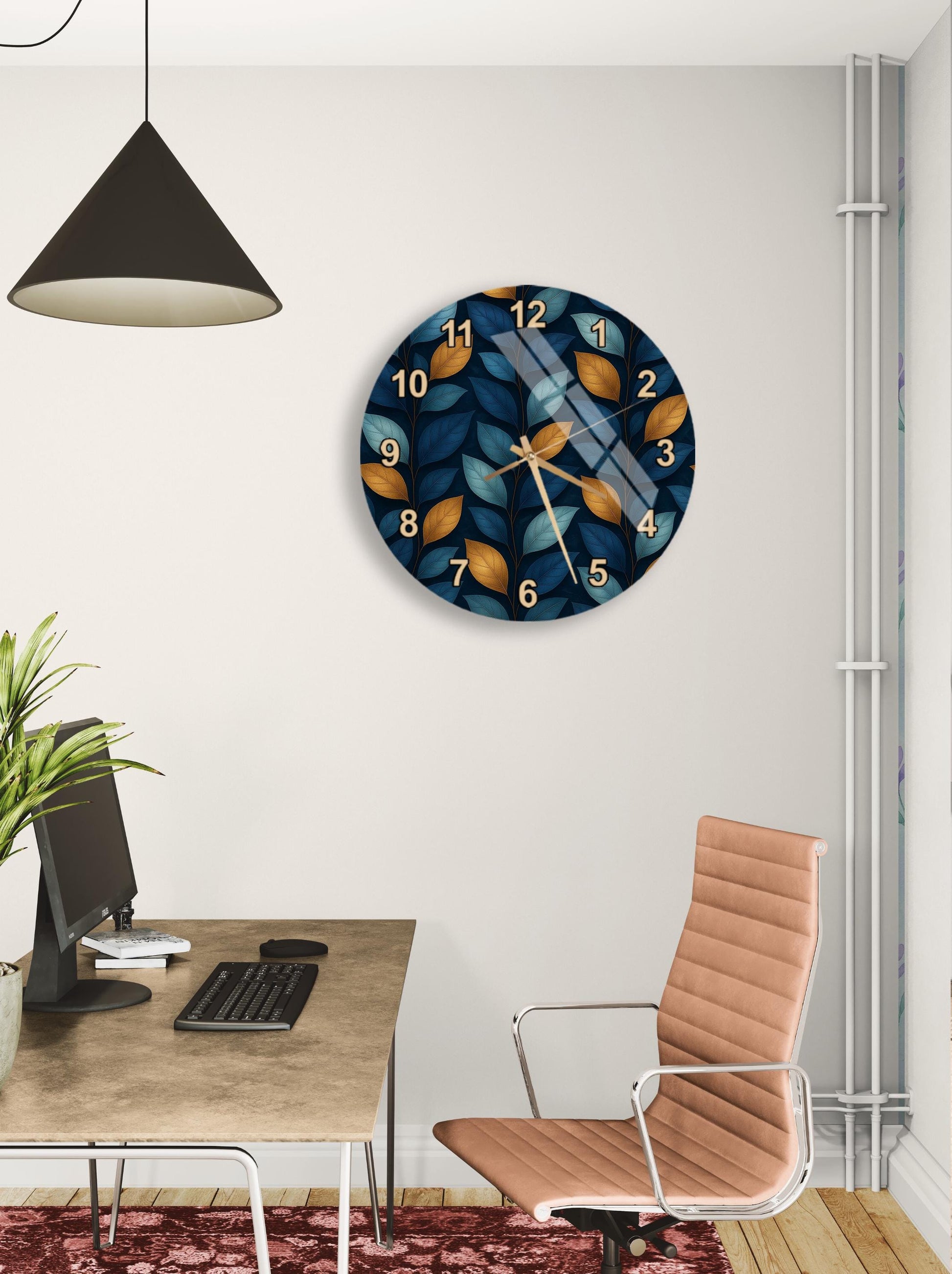 a modern office space with a large wall clock displaying a leaf pattern, a wooden desk with a computer setup, and a brown leather office chair.