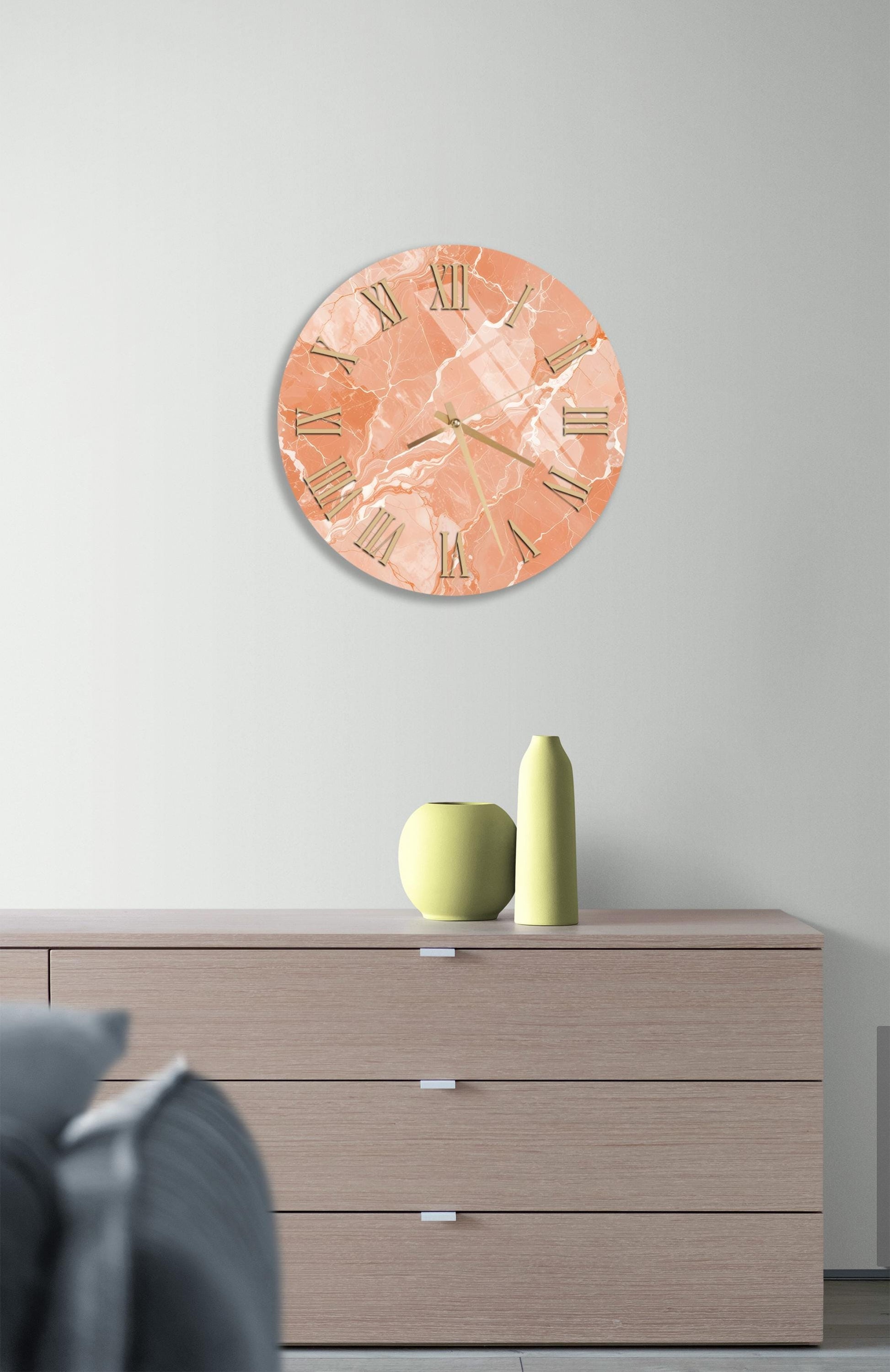 a modern living room with a wooden dresser, a round clock with a marble-like design, and a small green vase on the dresser.