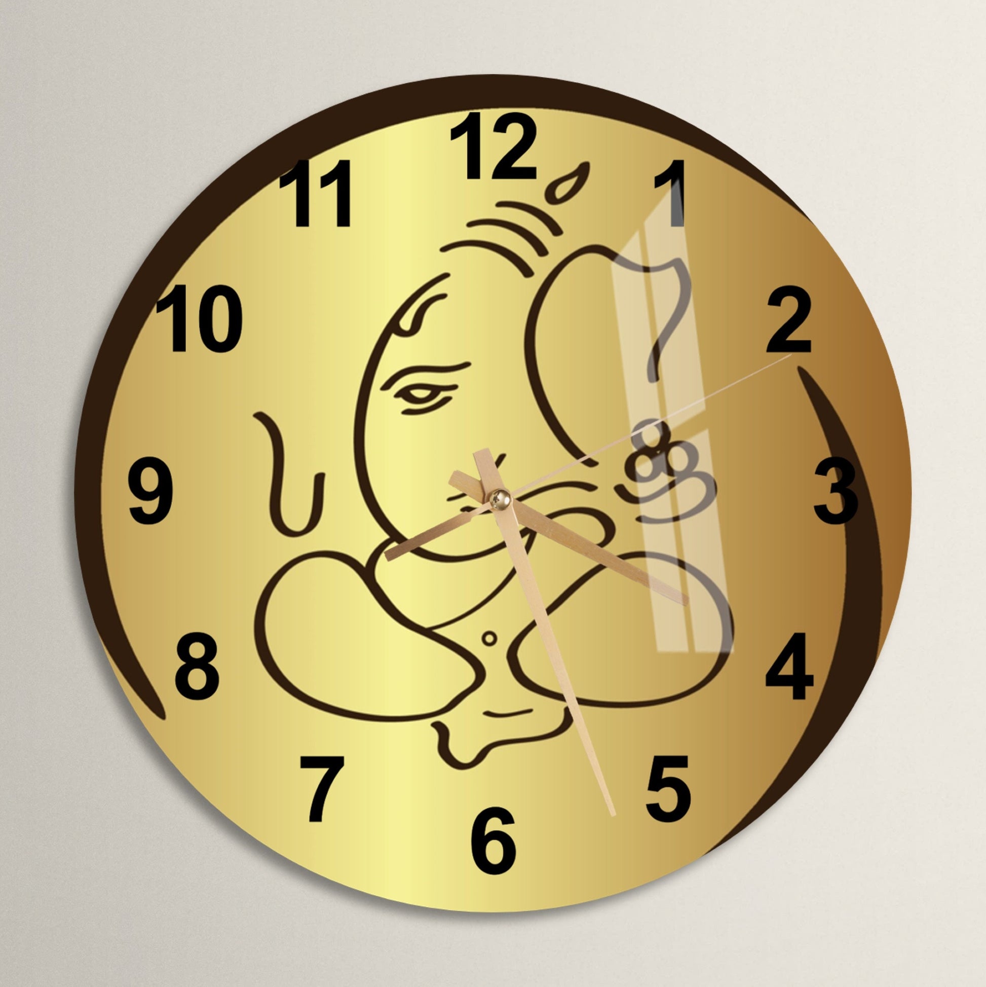 a gold clock with a drawing of a baby on it