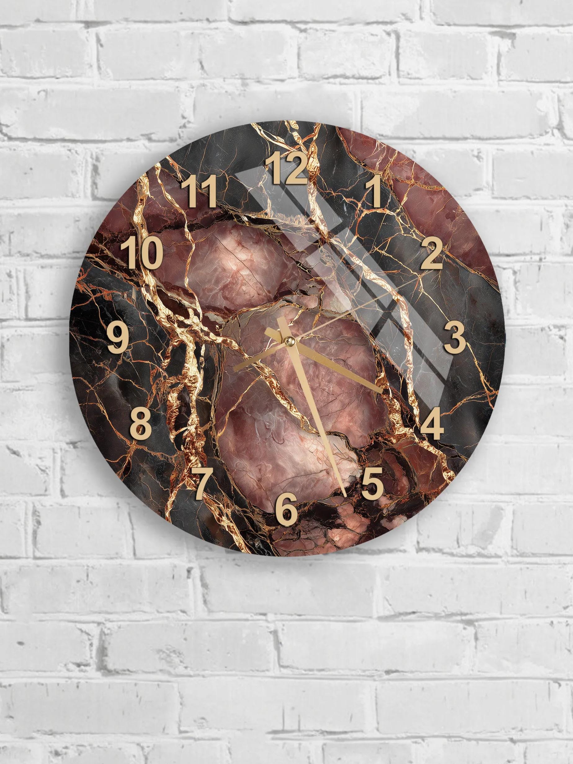 A round wall clock with a marble-like design, featuring gold and black elements.