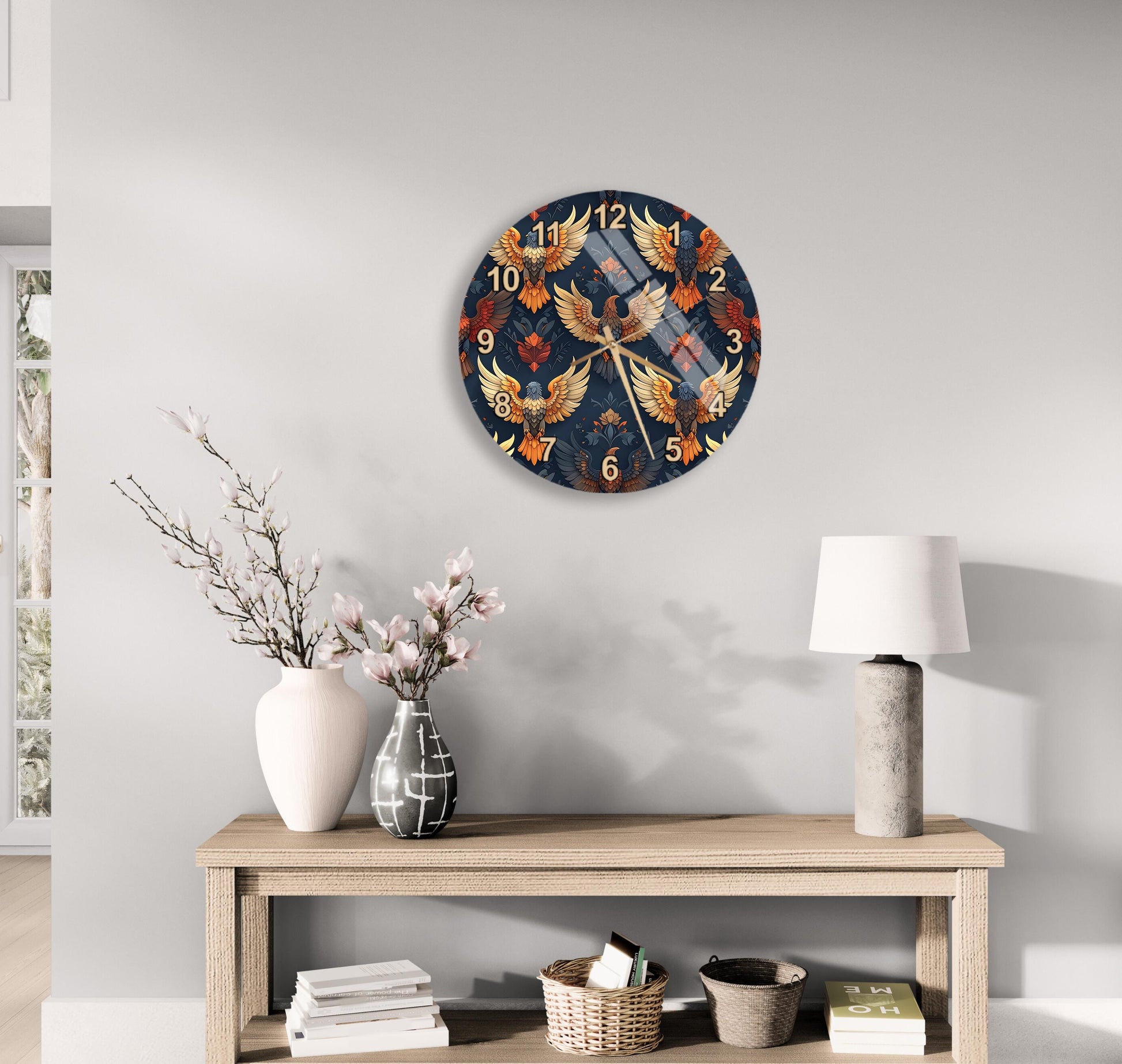 a wall clock with a dragon design, a wooden table with a lamp, a vase with flowers, and some books on a shelf.