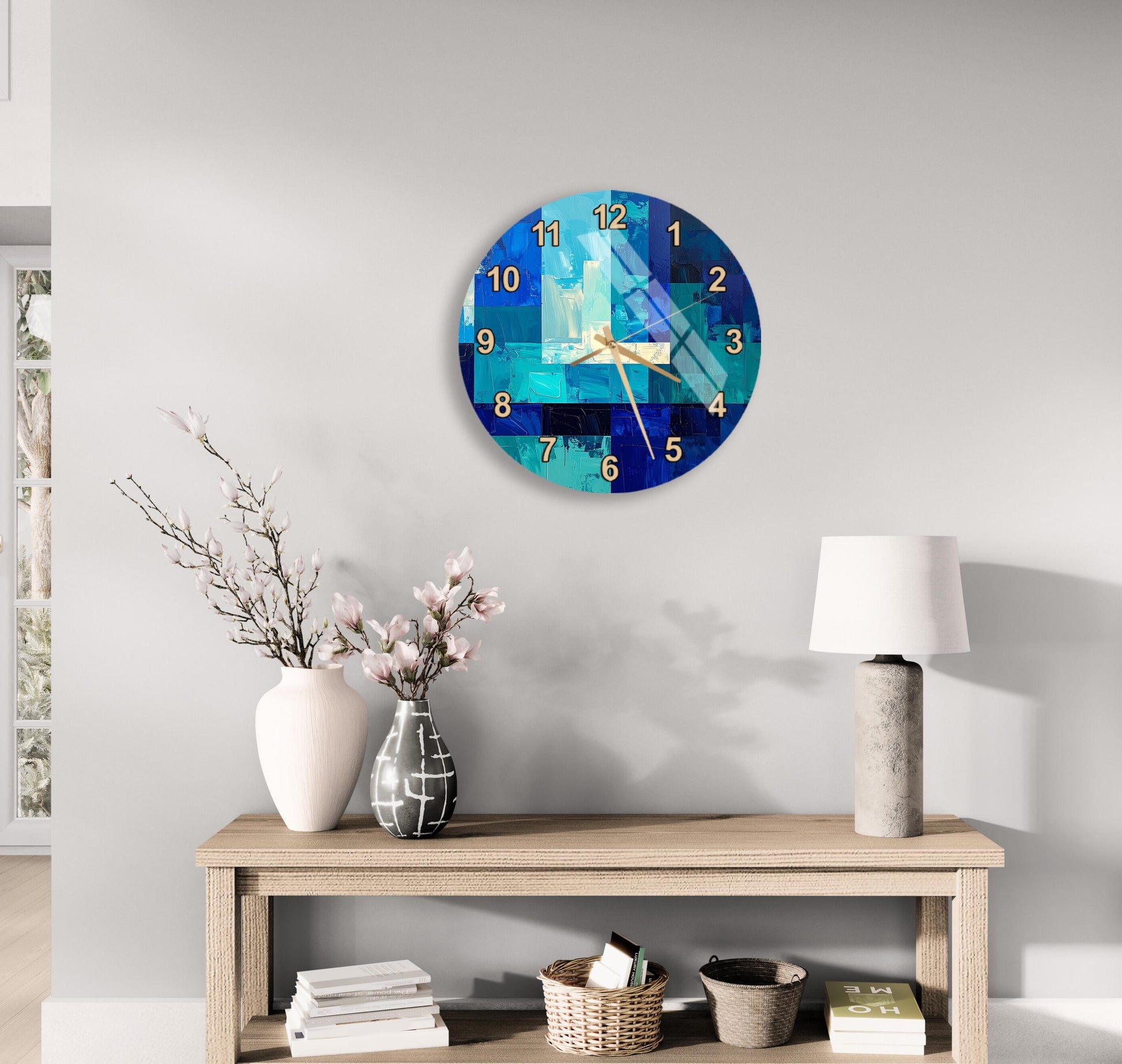 a modern living room with a wooden table displaying a vase of flowers, a lamp, and a clock on the wall.