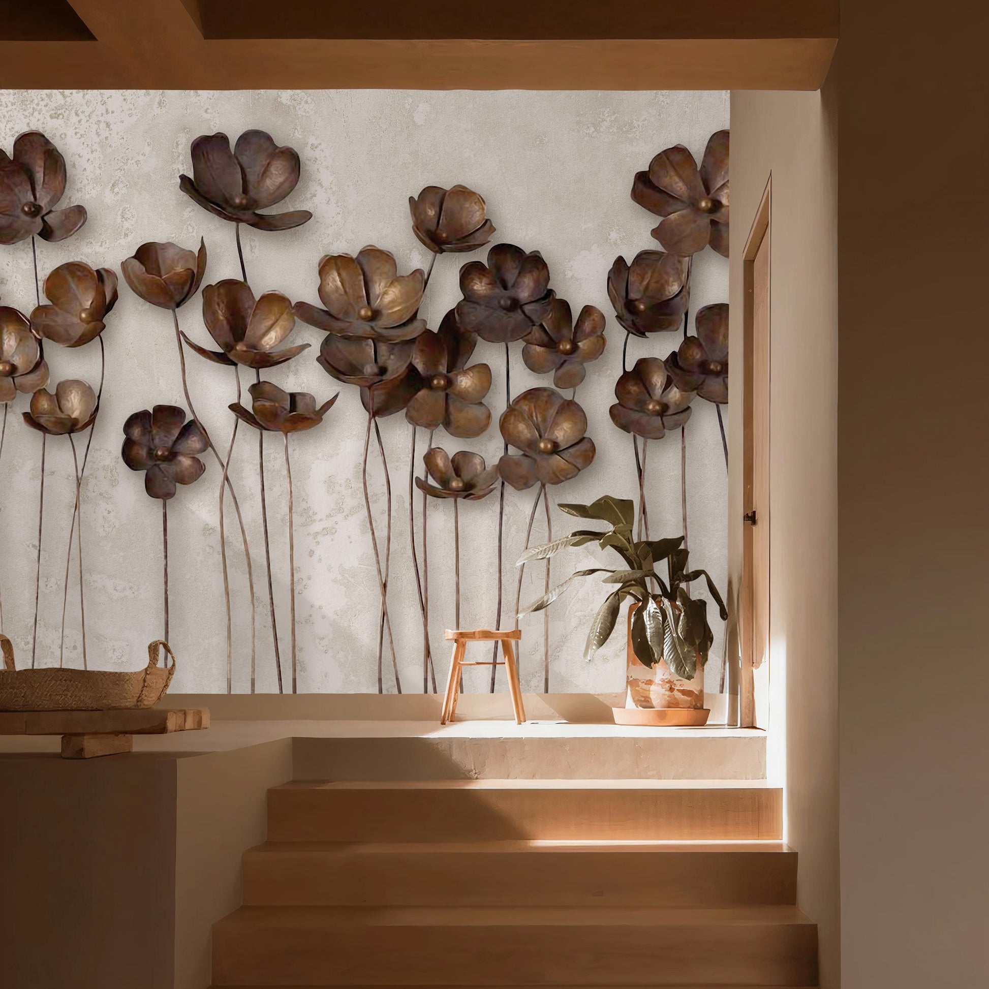 a wall adorned with a collection of large, intricately designed metal flowers, creating a striking visual display. The wall is set against a light-colored background, which highlights the metallic sheen of the flowers. In the foreground, there is a wooden staircase leading up to a higher level, and a small potted plant is placed on the steps. The overall composition of the image is visually appealing and draws attention to the artistic elements of the wall design.