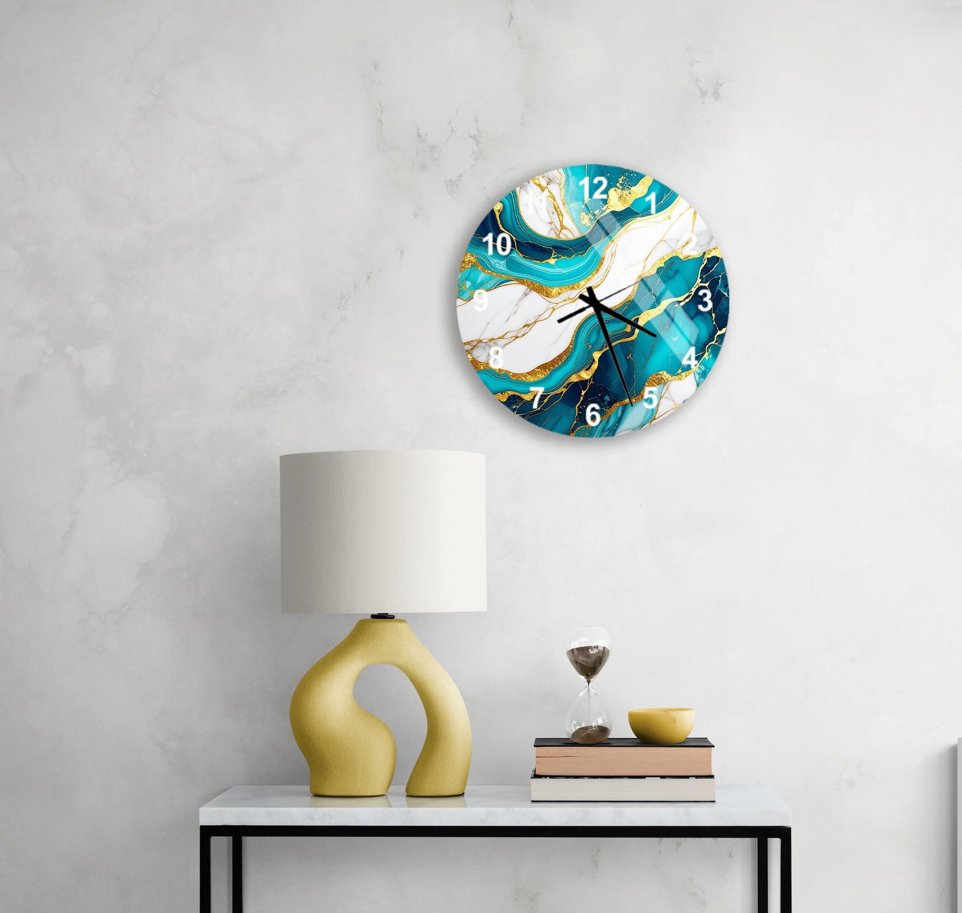 a modern and stylish living room with a white marble wall, a round clock with a marble and gold design, a yellow lamp with a unique curved base, and a stack of books on a white table.