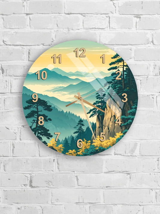 A wall clock with a scenic mountain landscape design, featuring a forest, mountains, and a sunset sky.