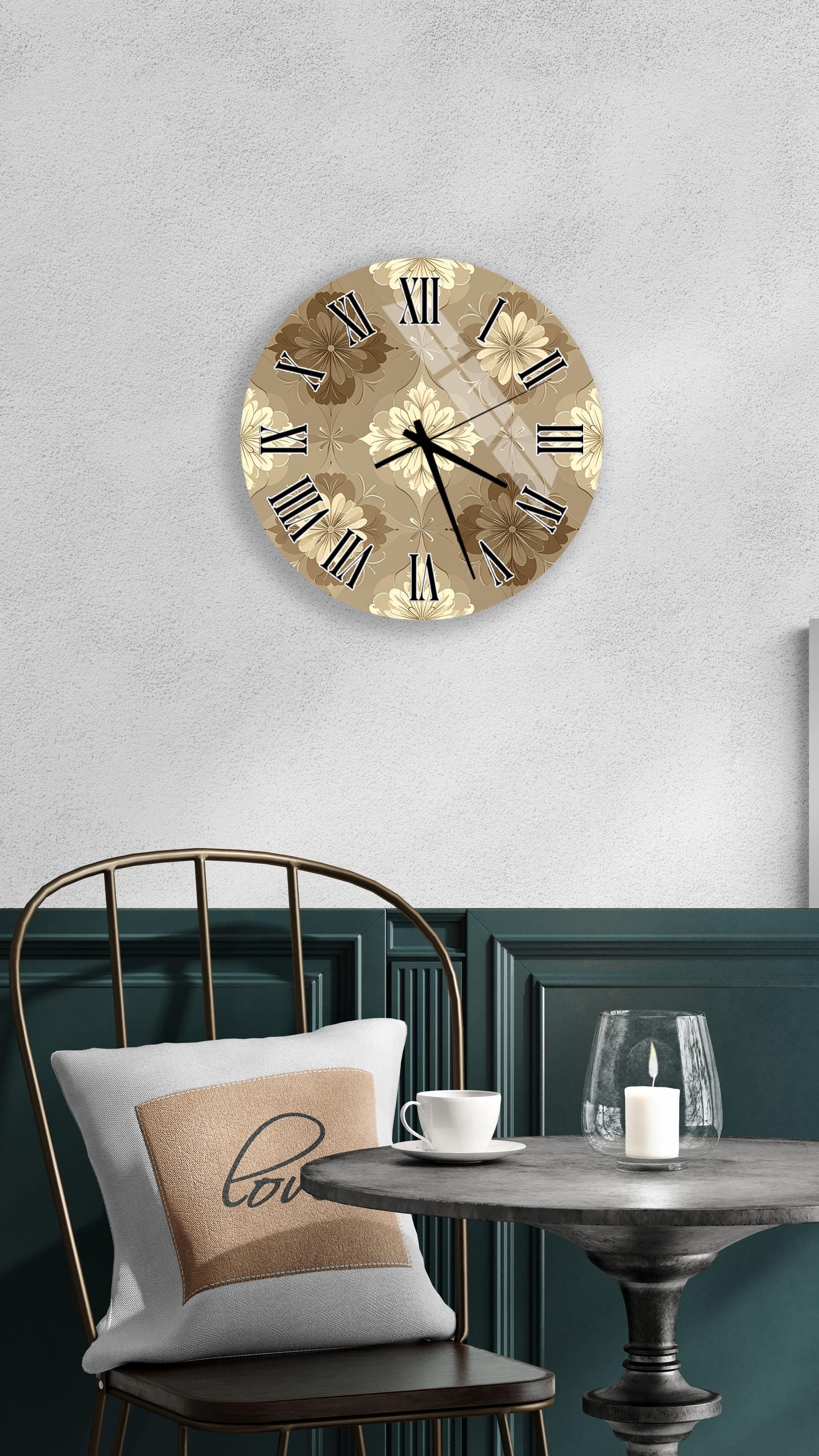 a wall clock with a floral design, a round table with a white cup and a candle, and a chair with a pillow on it.