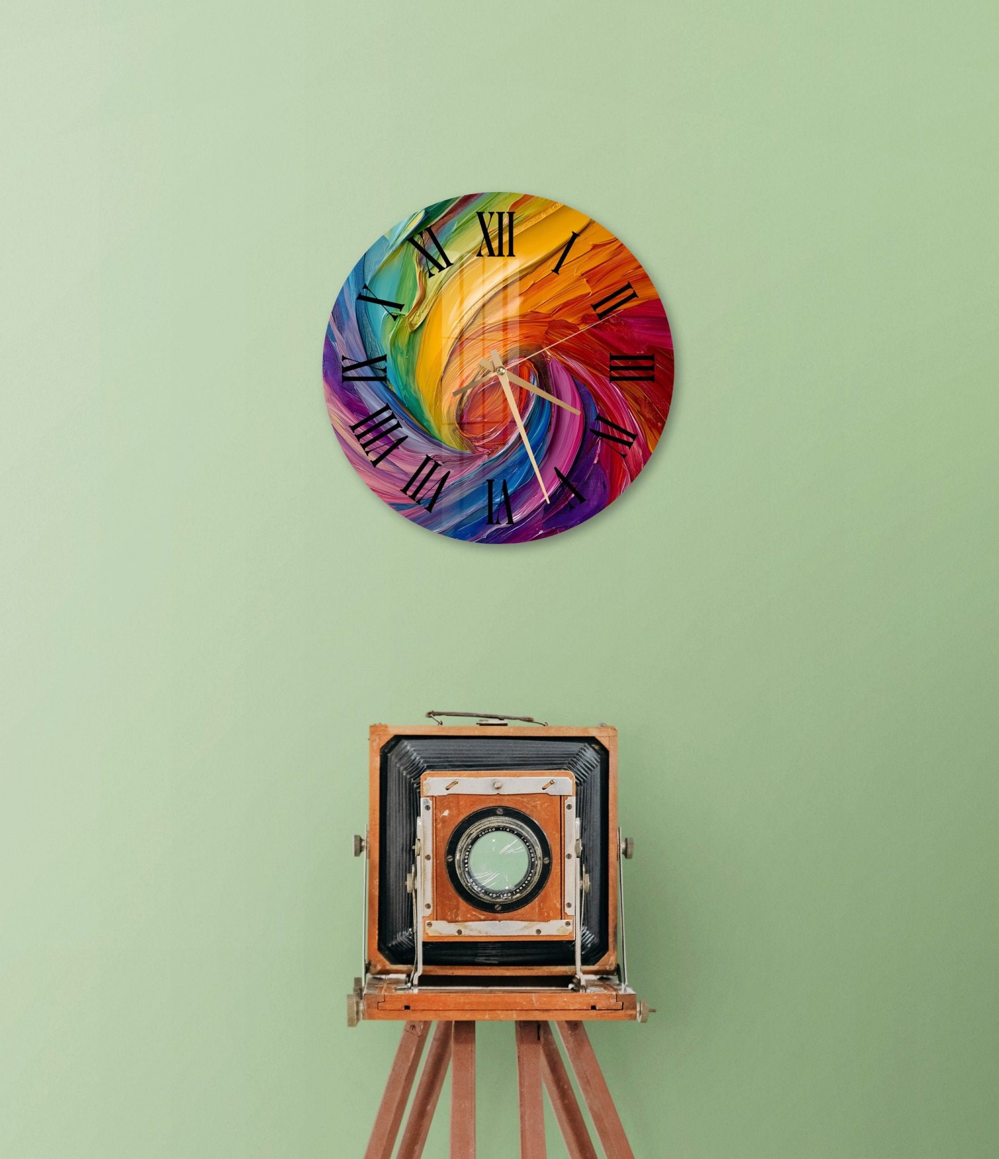 a colorful clock on a green wall next to an old camera