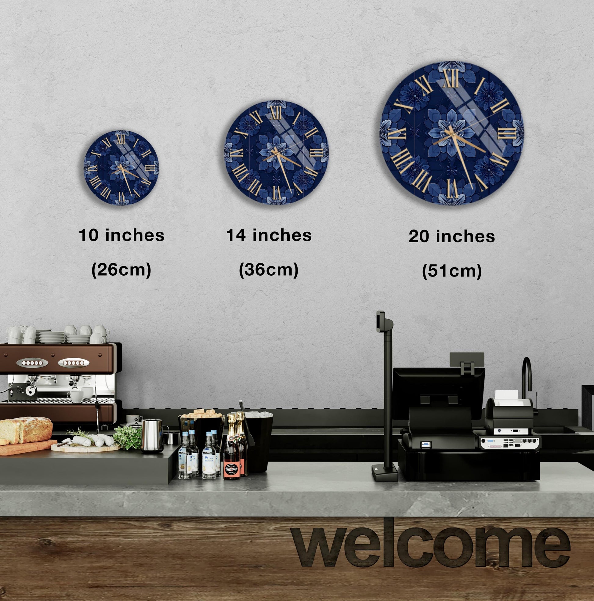 a wall with three clock faces of different sizes, each displaying a blue floral design. Below the clock faces, there is a counter with various items such as bottles and a cash register. The word "welcome" is written on the counter.