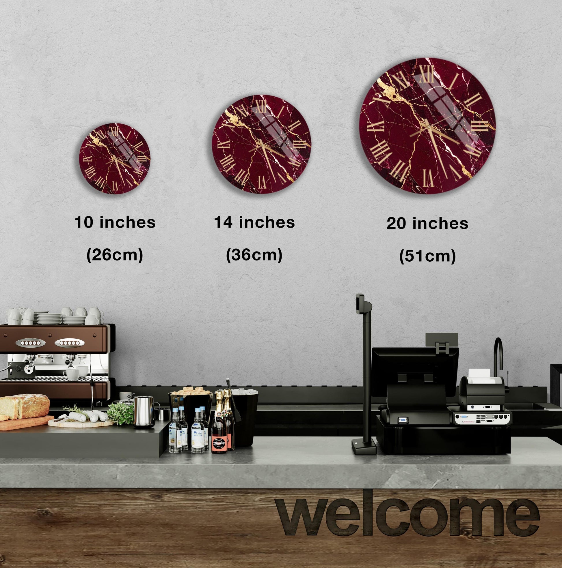 a wall with three clock designs, each with a different size and style, and a counter with various items on it.