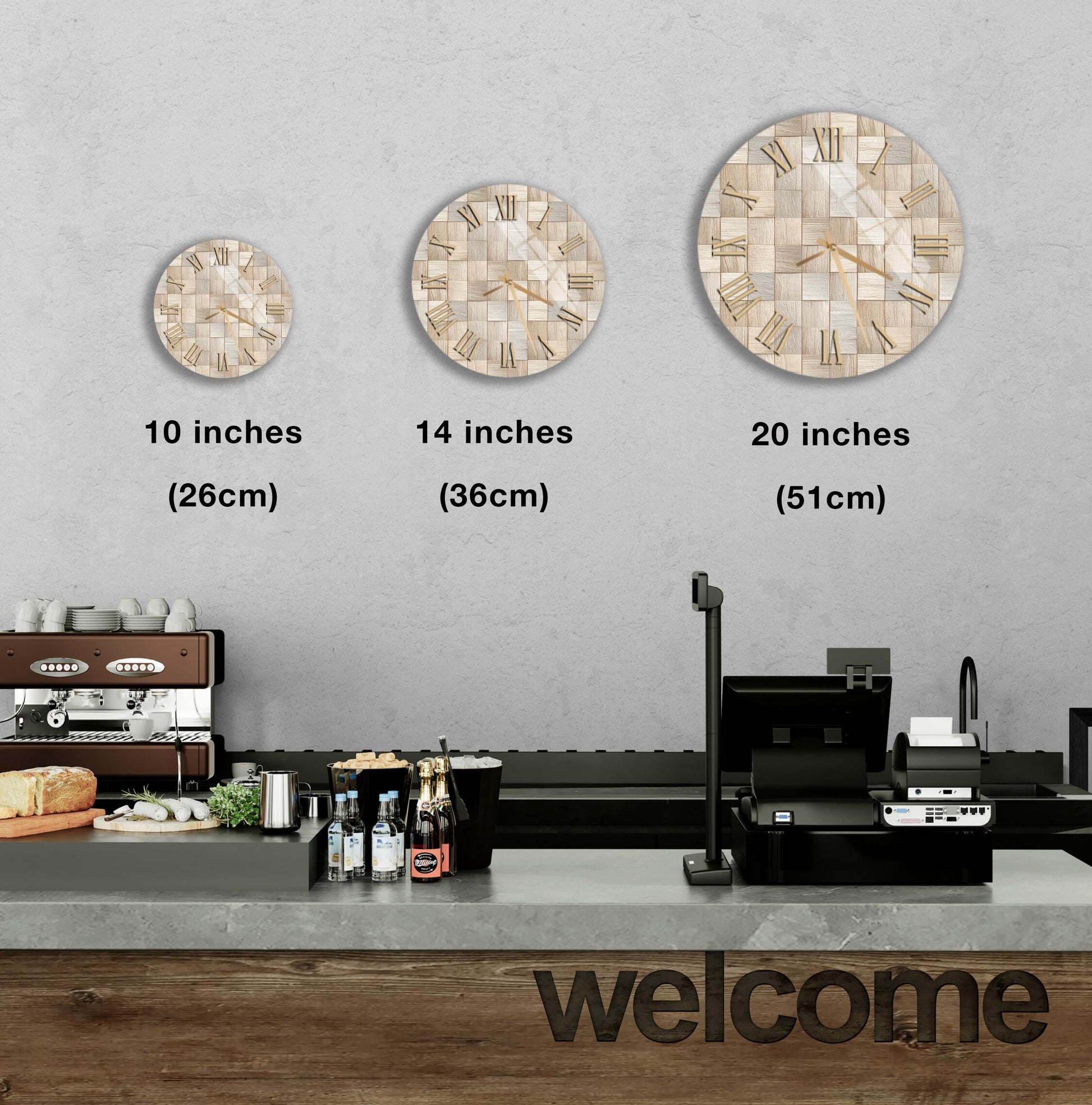 a counter with a cash register, a coffee machine, and three wall clocks of different sizes. The clocks are arranged in a row, with the largest clock being 20 inches and the smallest being 10 inches. The counter also has a welcome sign, and there are various bottles and a cup visible on the counter.