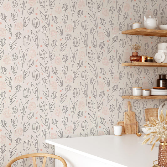 a kitchen interior with a white table, shelves displaying various kitchen items, and a patterned wallpaper with a repeating design of flowers and leaves.