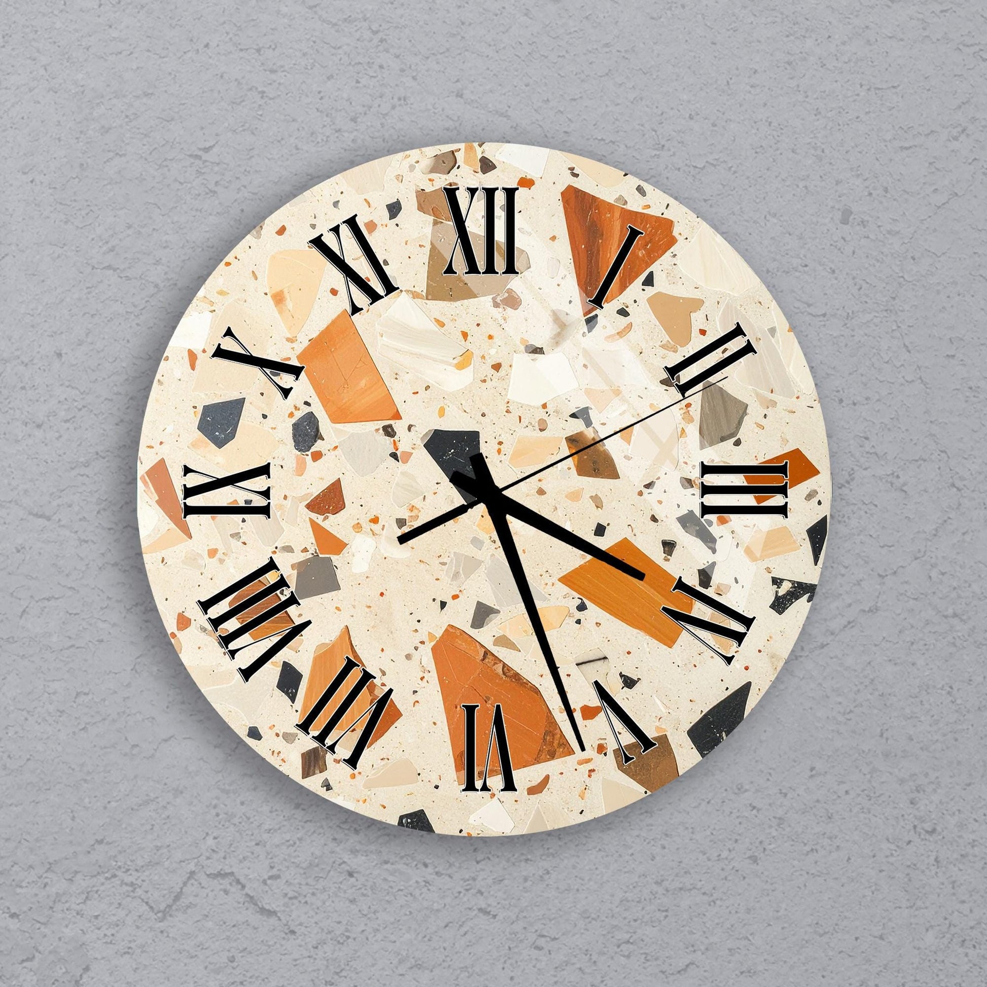 a round clock with a mosaic-like design on its face, set against a gray background.