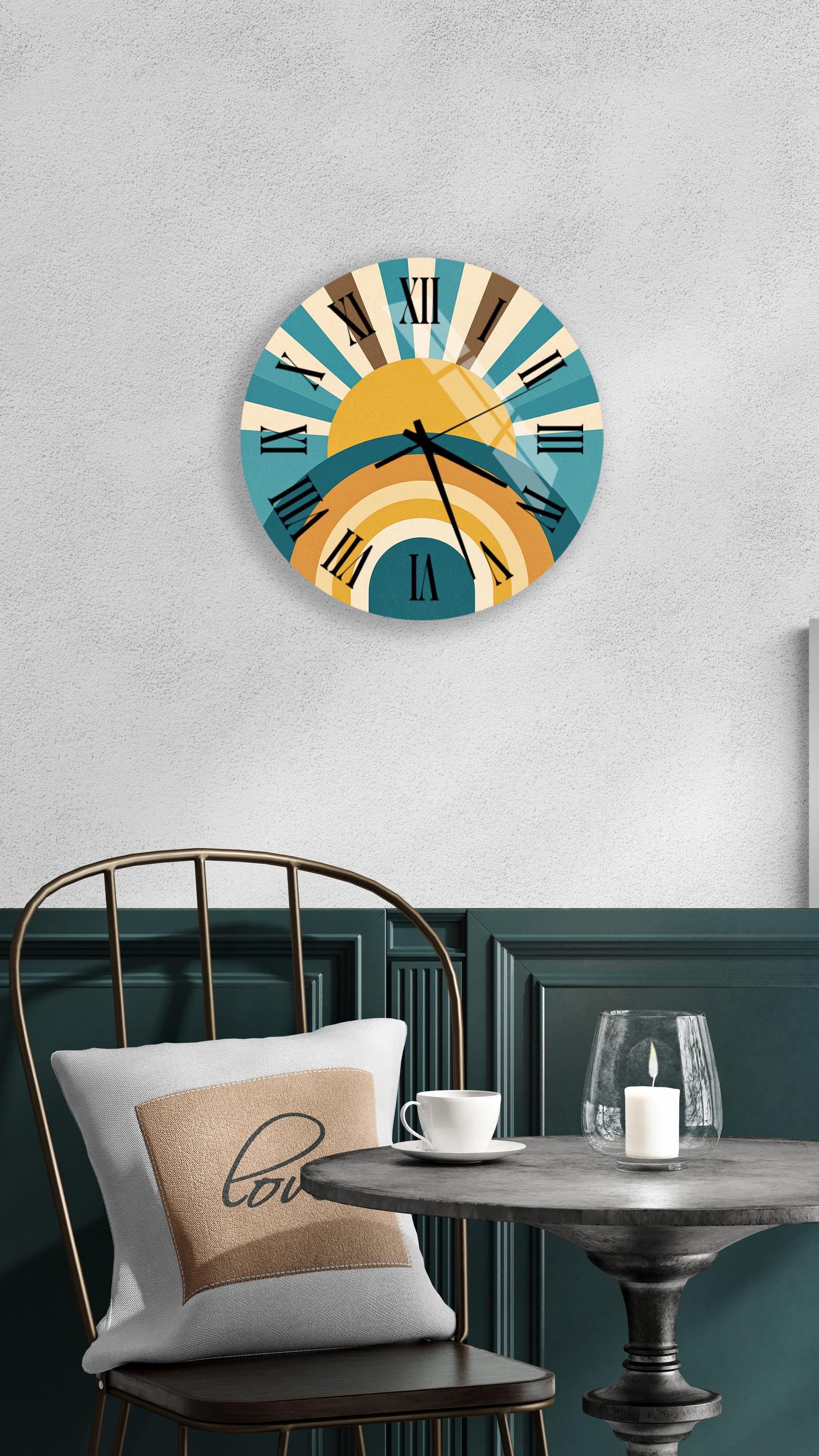 a wall clock with a sun-like design, a round table with a white cup and a candle, and a chair with a pillow.